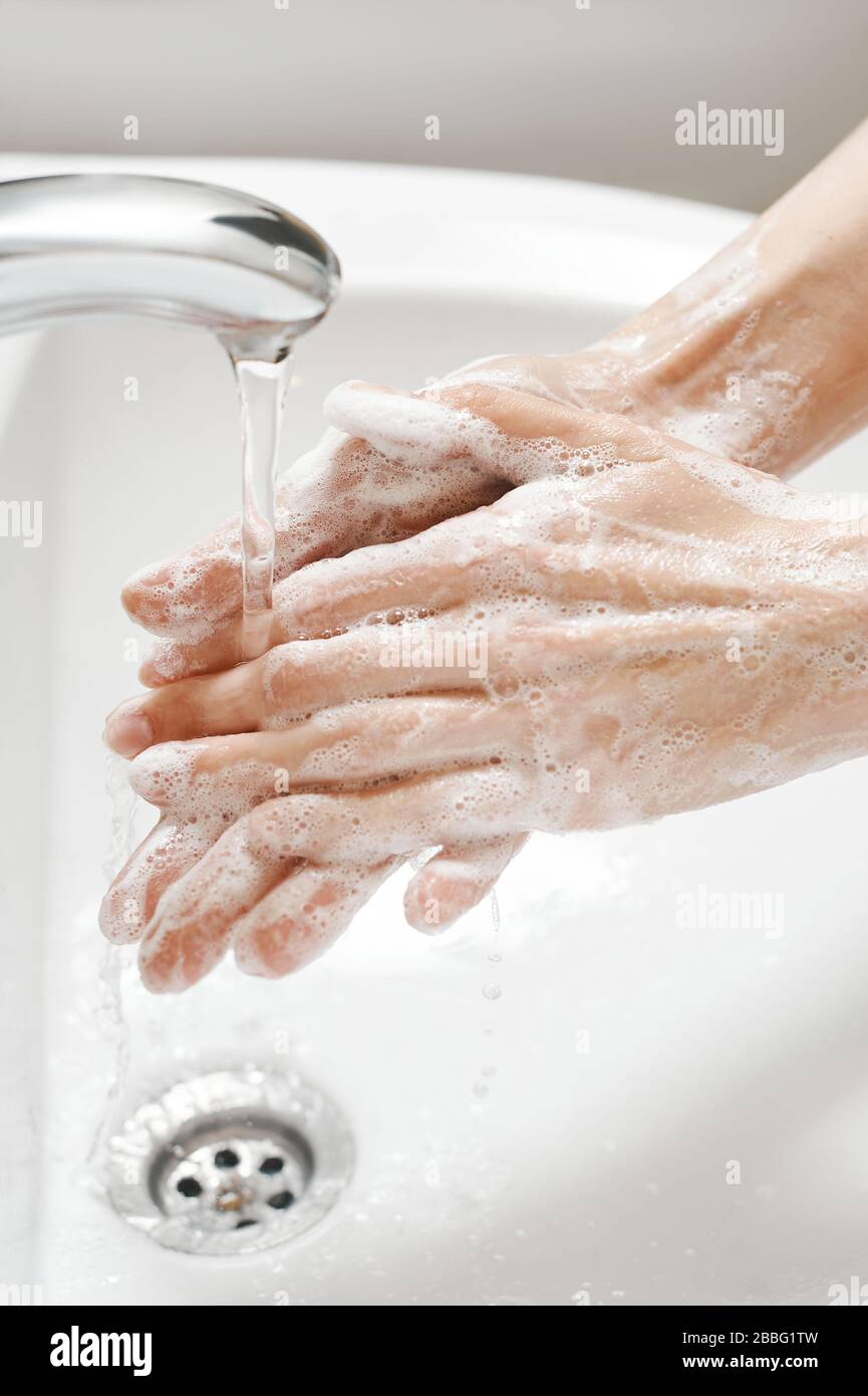 Bucket full of soap suds and hand washing Stock Photo - Alamy