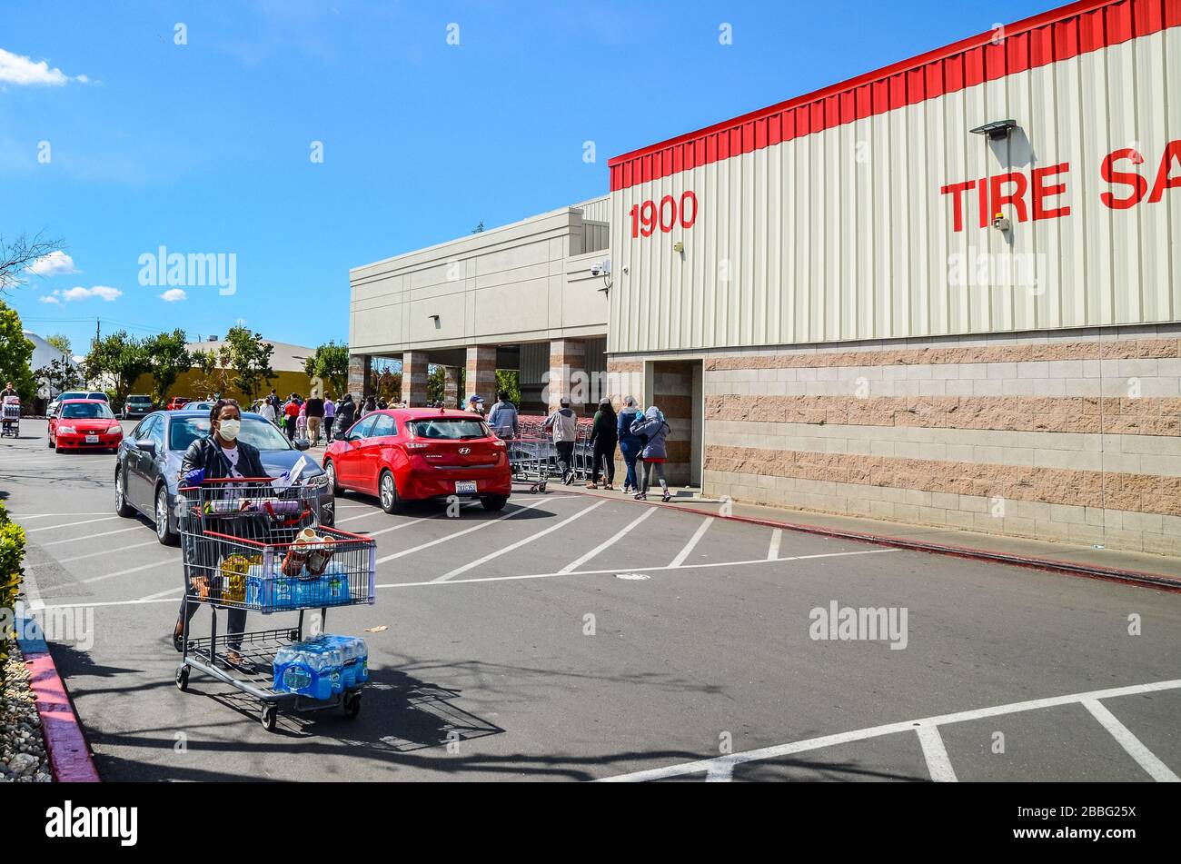 A Costco customer with mask with supplies at the store in San Leandro California USA Stock Photo