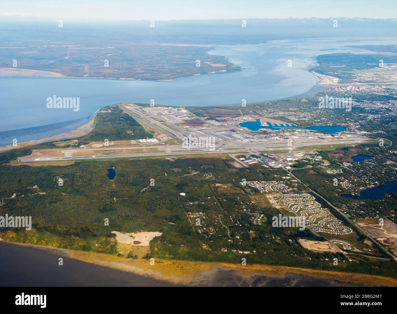 Aerial overview of Ted Stevens International Airport in Alaska, USA. Kincaid Park and Anchorage Airport visible in a sunny day during summer. Stock Photo