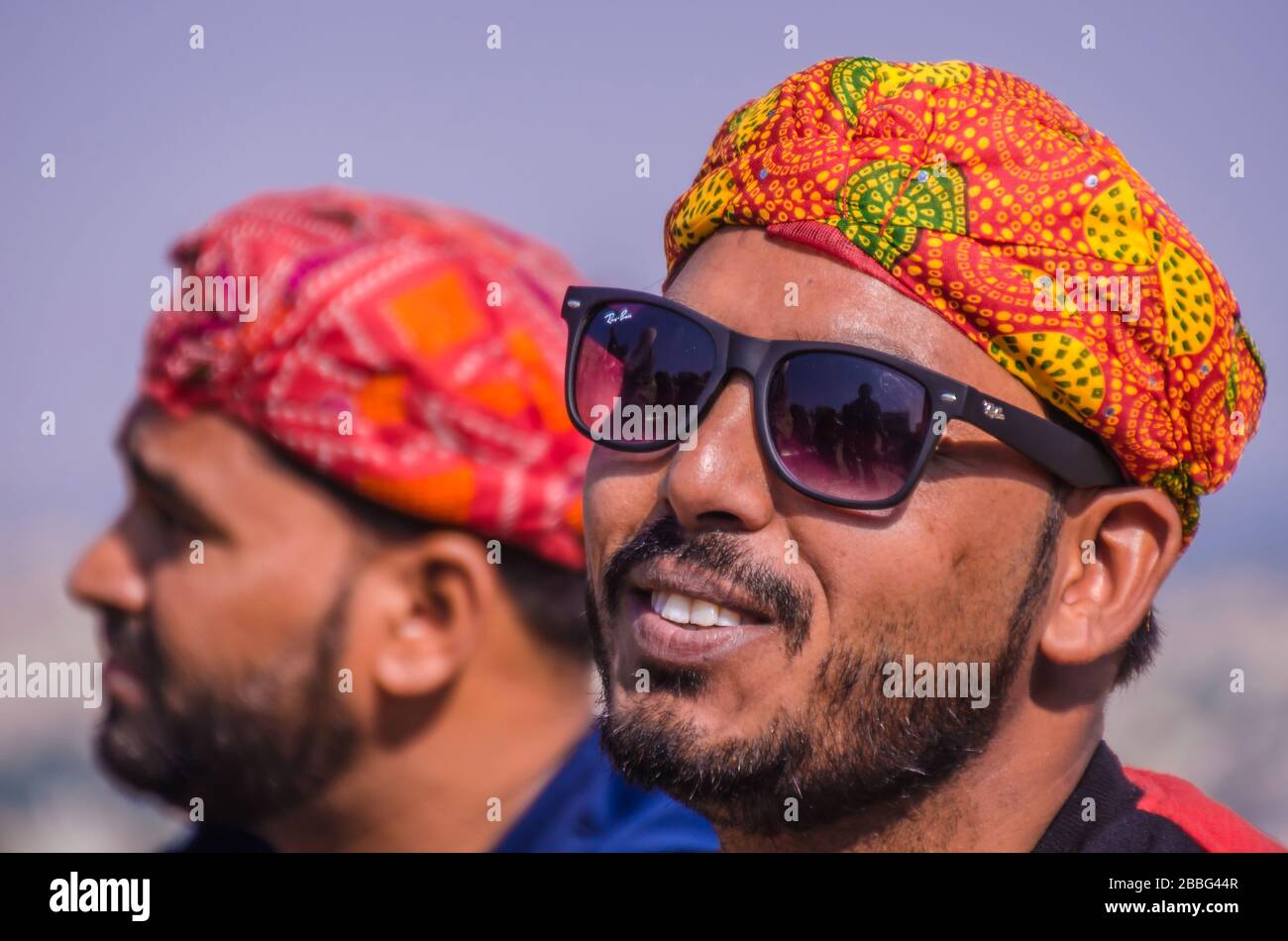 JAISALMER, RAJASTHAN, INDIA – NOV. 29, 2019: Portrait of young tribal men wearing traditional colorful turban in Jaisalmer Fort, Rajasthan, India, Stock Photo