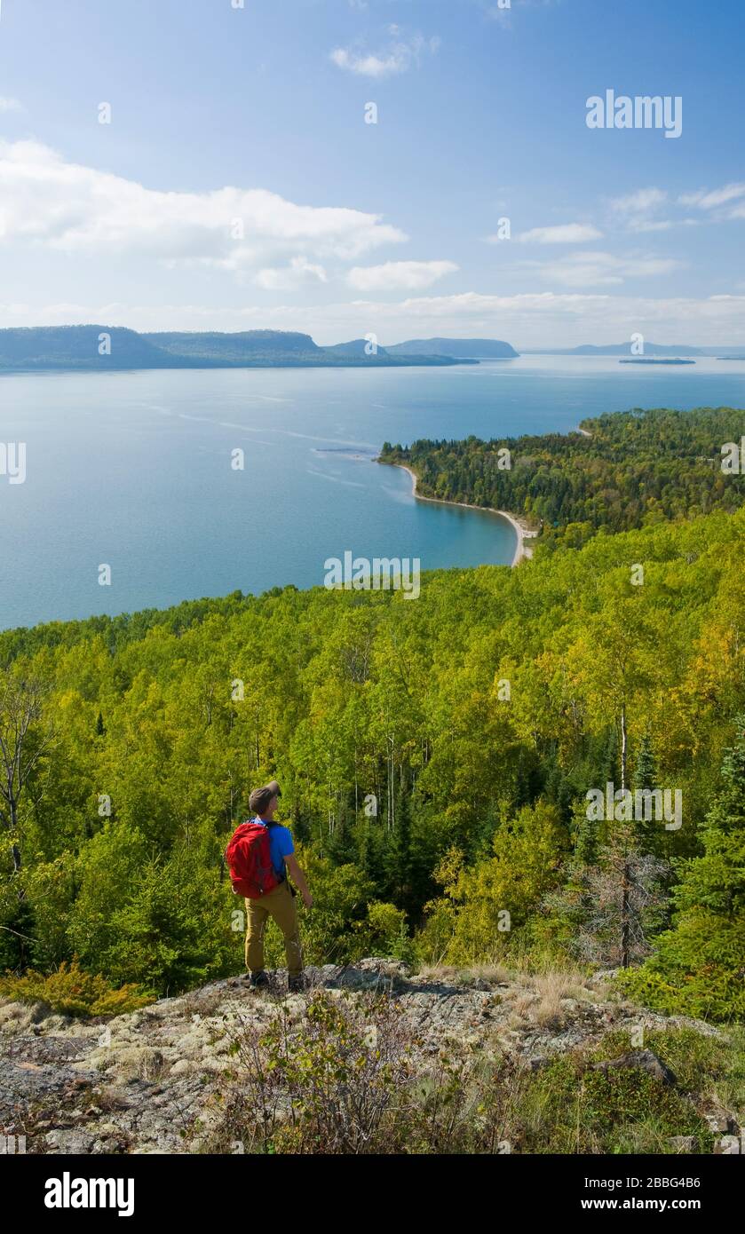 a hiker looks out over Lake Superior near Nipigon, Ontario, Canada Stock Photo