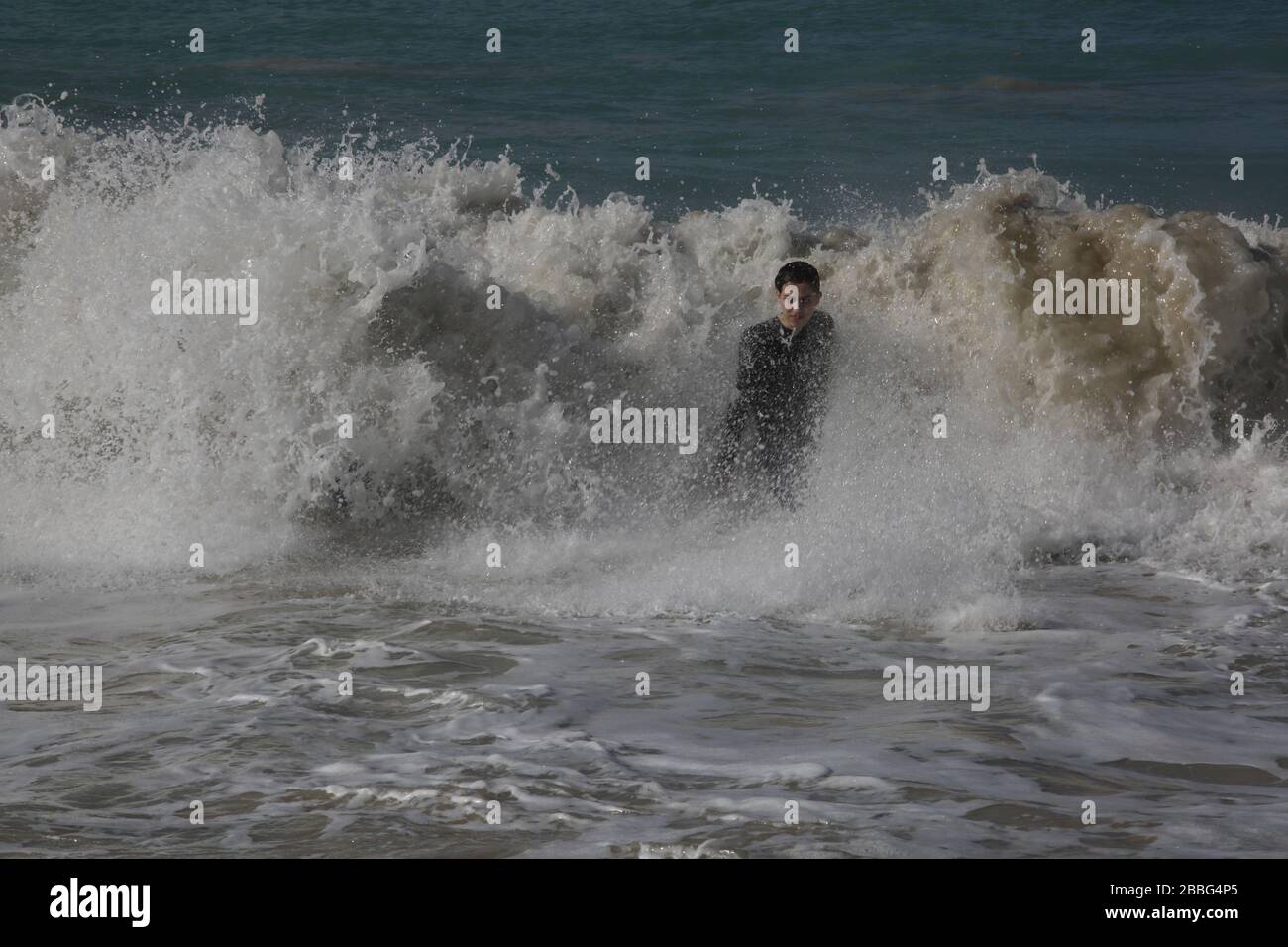 Man in waves hi-res stock photography and images - Alamy