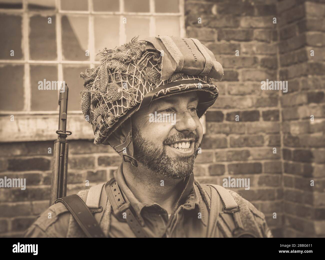 Close up smiling young man isolated outdoors, dressed in American US military man soldier costume, 1940's summer event, Black Country Living Museum UK. Stock Photo