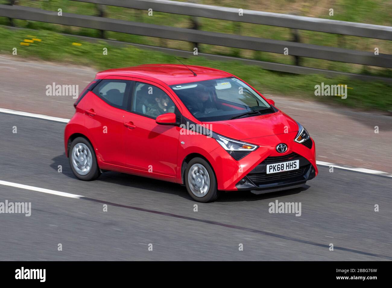 2018 red Toyota Aygo X-Play VVT-I; Vehicular traffic moving vehicles, vehicle driving, roads, motors, motoring on the M6 motorway highway Stock Photo