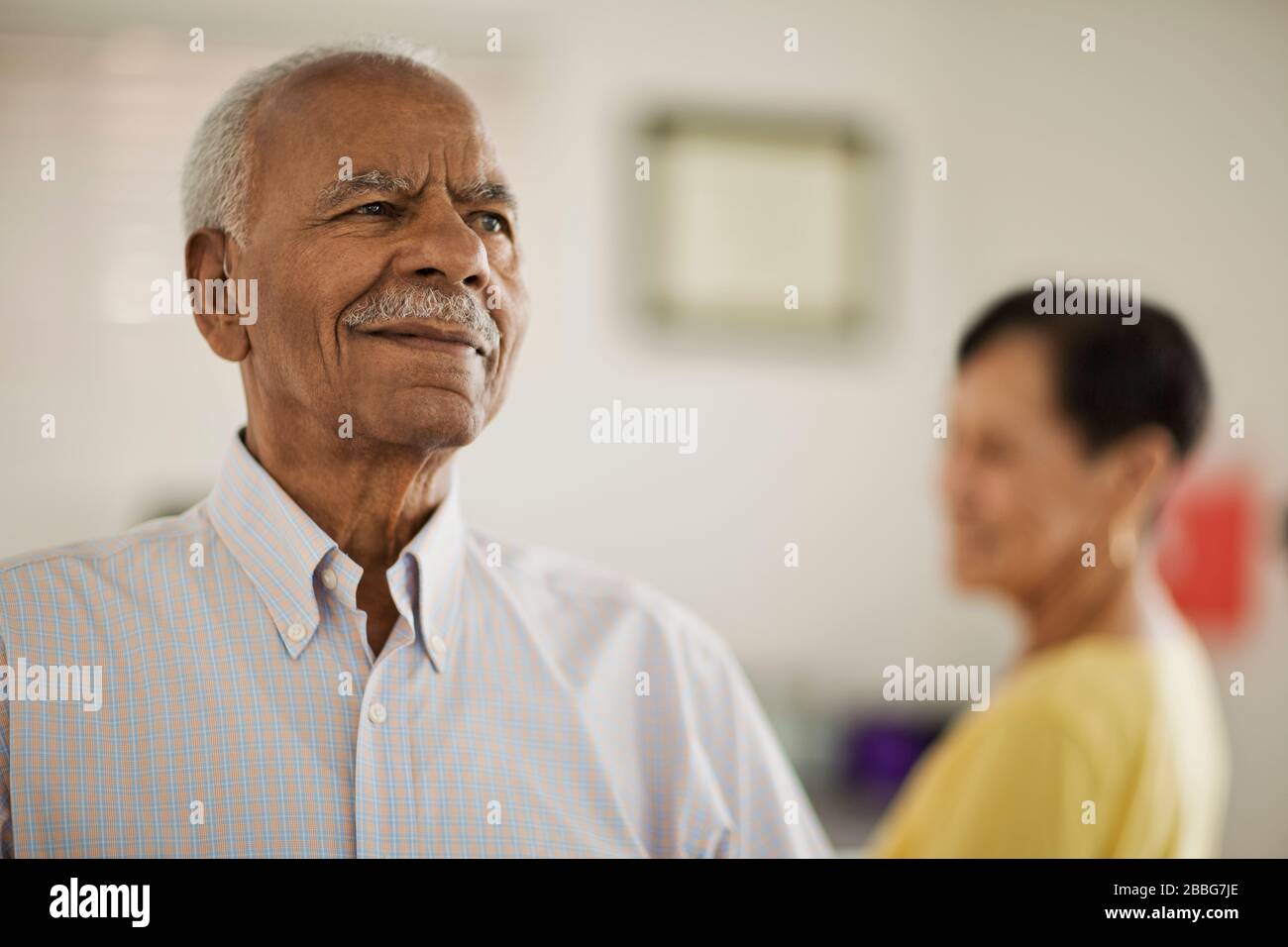 Confident senior man inside his house with his wife. Stock Photo