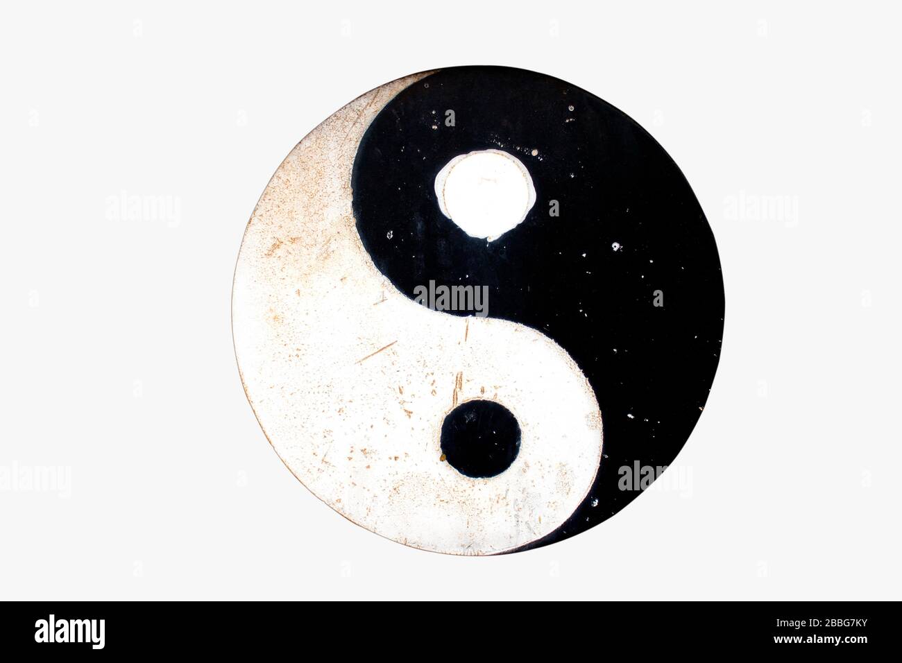 Isolate Yin Yang symbol on old metal plates on white background with clipping path. Stock Photo