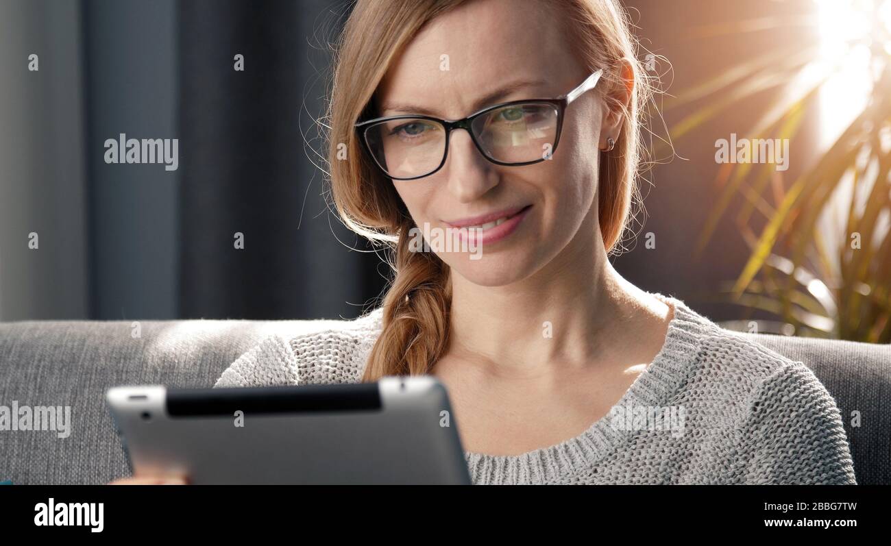 Adult woman using digital tablet Stock Photo