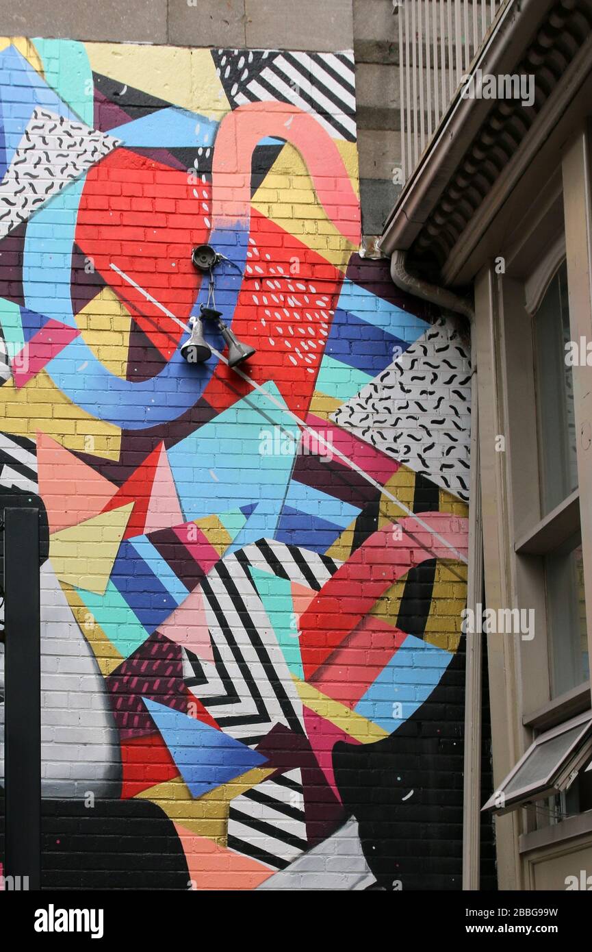 The wall is decorated with some creative artwork. Stock Photo