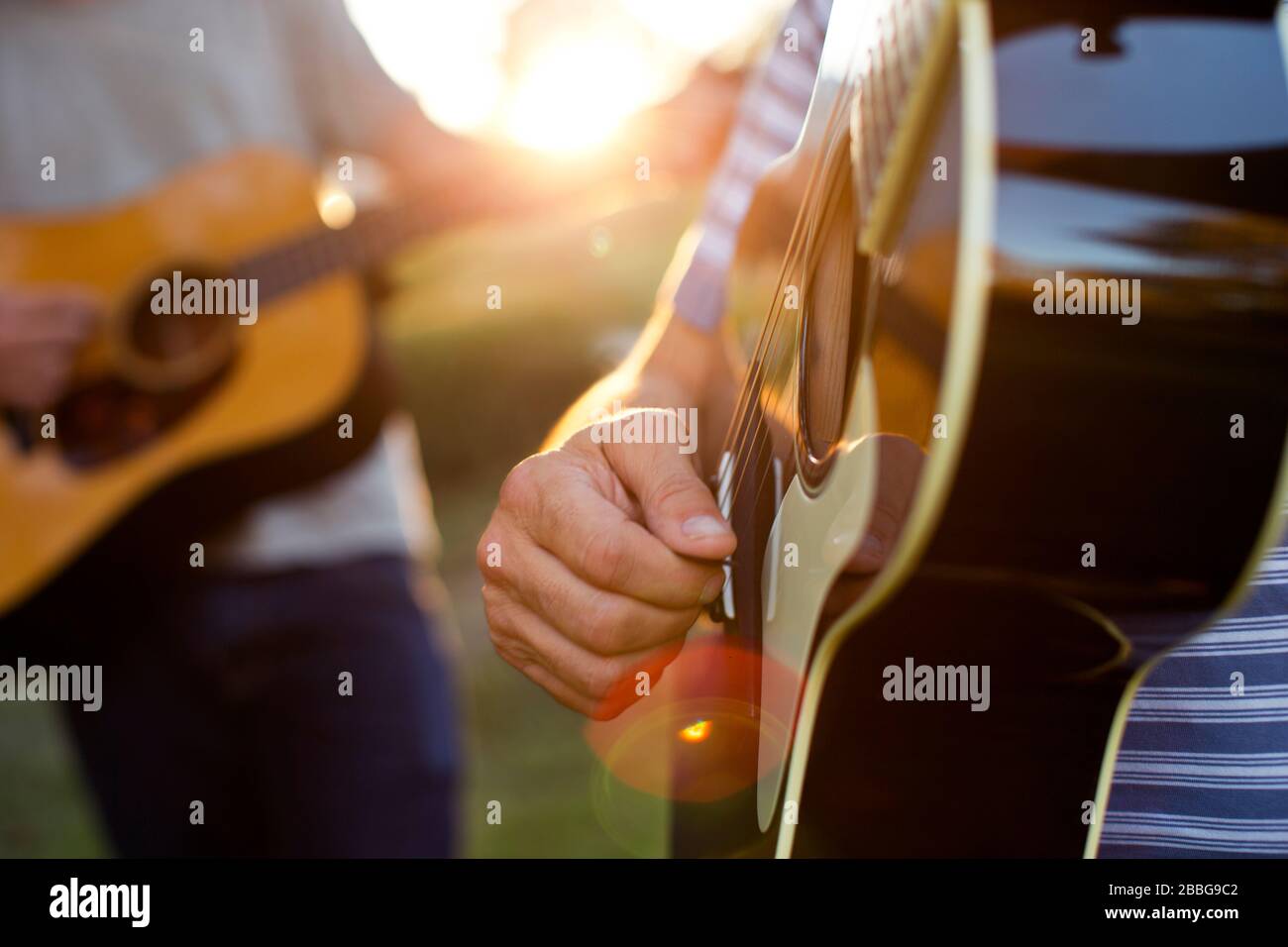 Father and son practicing playing guitar together Stock Photo