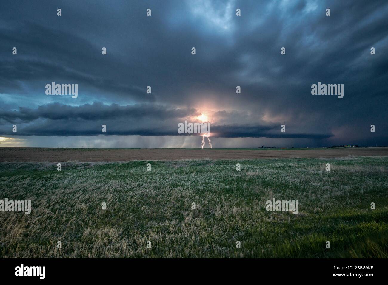 Storm with lightning strikes over a rural field in Nebraska, United States Stock Photo
