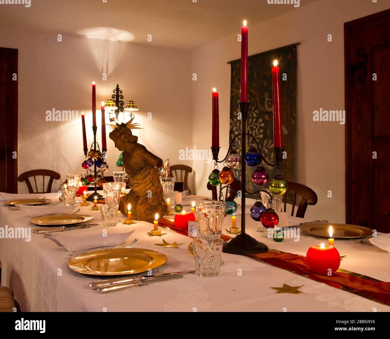 Dining Table With Christmas Decorations And Burning Candles Stock Photo Alamy