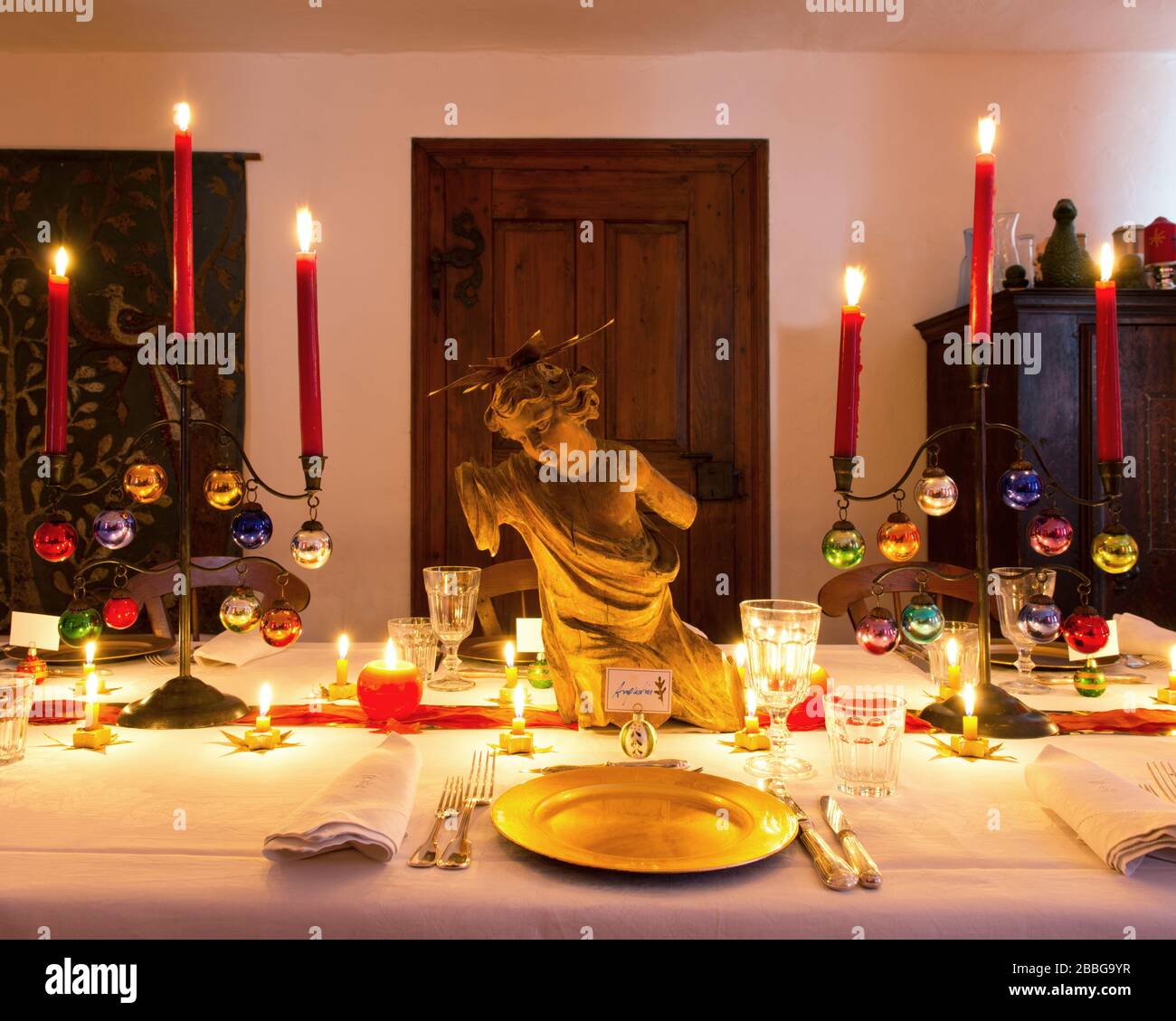 dining table with Christmas decorations and burning candles Stock