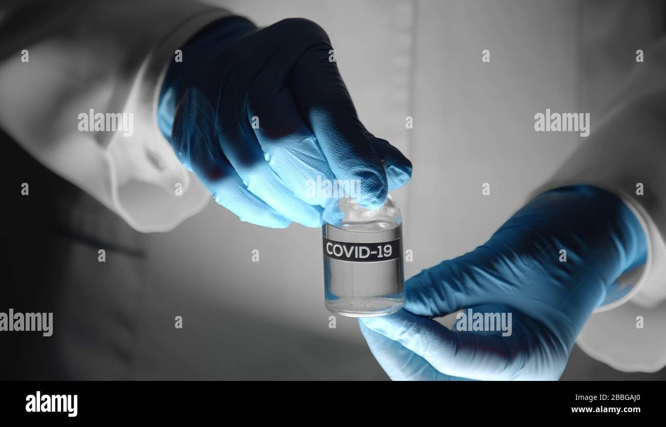 Doctor's hands holding vaccine vial Stock Photo