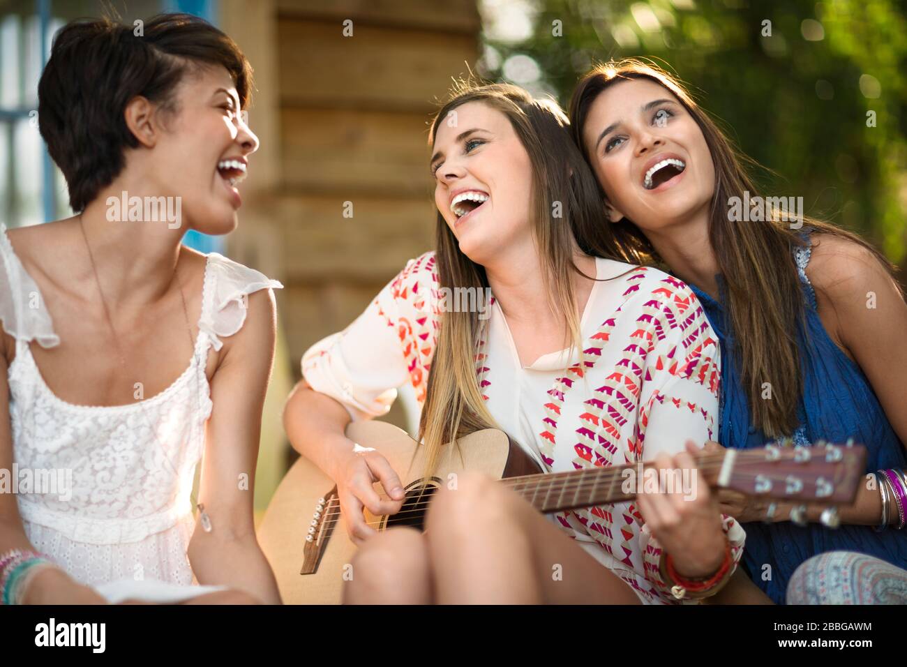 Three young women enjoying summer Stock Photo - Alamy