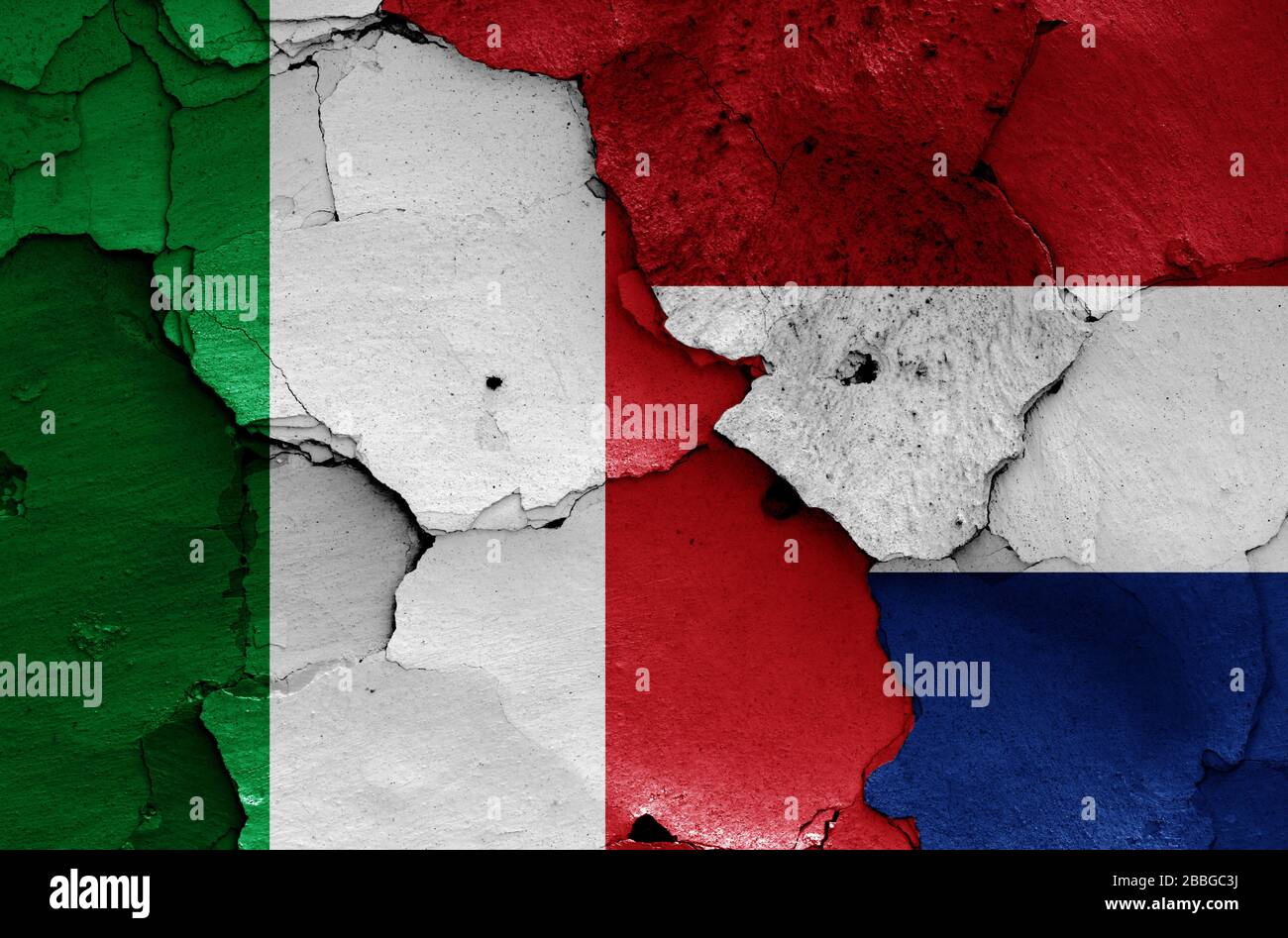 flags of Italy and Netherlands painted on cracked wall Stock Photo