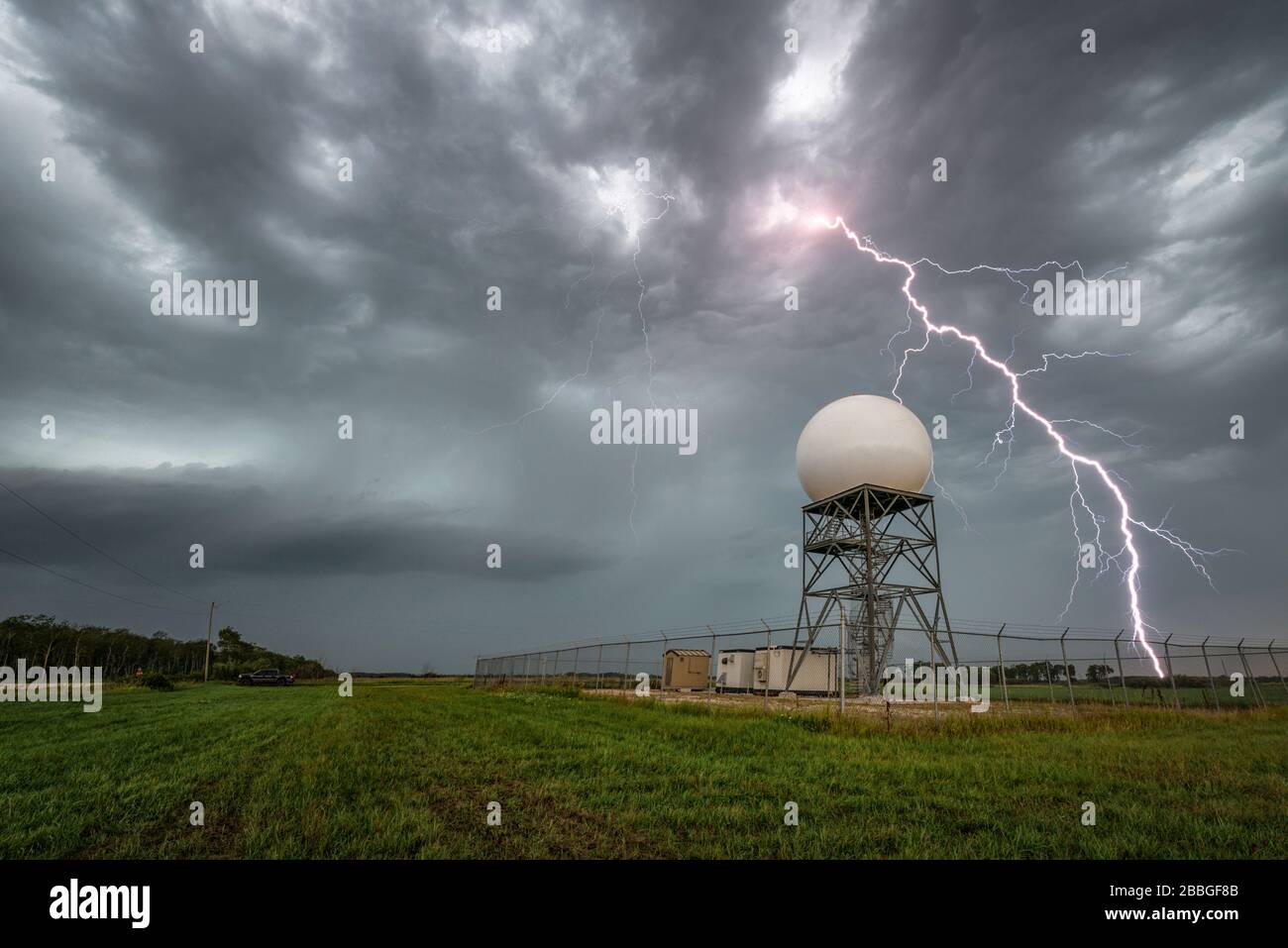 Storm with close range lightning striking near the woodlands radar station in rural Manitoba Canada Stock Photo