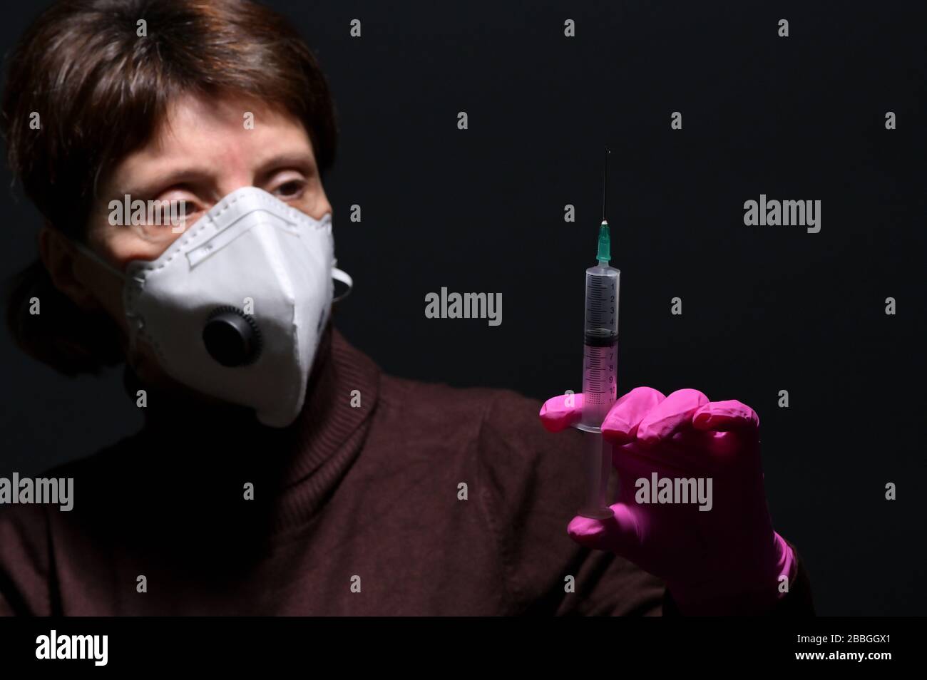 Woman Wearing Medical Protective Virus Mask and Syringe Stock Photo