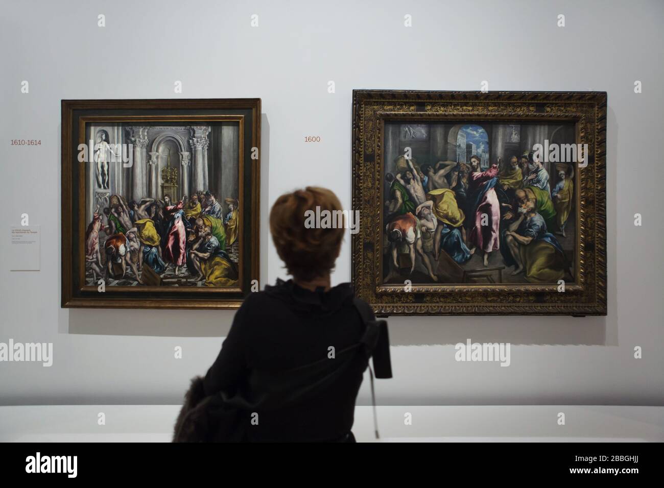 Visitor in front of the paintings 'Christ driving the Traders from the Temple' by Spanish mannerist painter El Greco dated from 1600 (R) and 1610-1614 (L) displayed at his retrospective exhibition in the Grand Palais in Paris, France. The first major exhibition in France ever to be dedicated to El Greco runs till 20 February 2020. Stock Photo