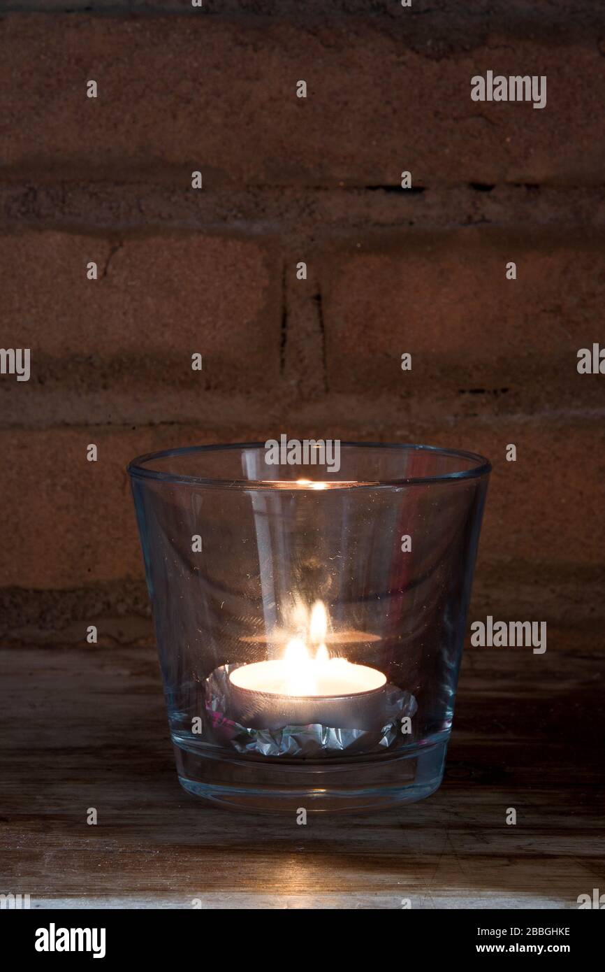 burning candle in glass cup Stock Photo - Alamy