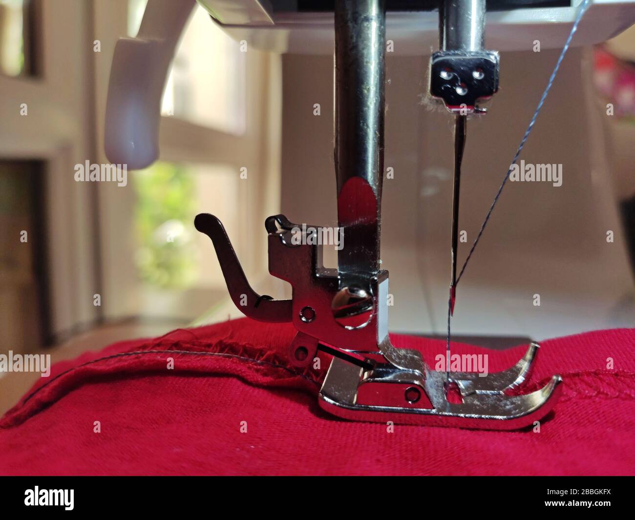 Closeup shot of needle and thread of modern sewing machine Stock Photo Alamy