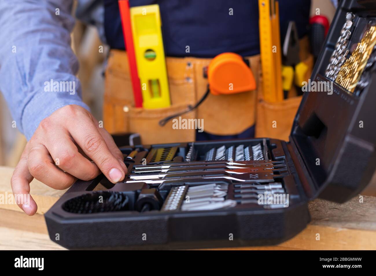 Close up picture of carpenters tool belt and work instruments on wooden ...