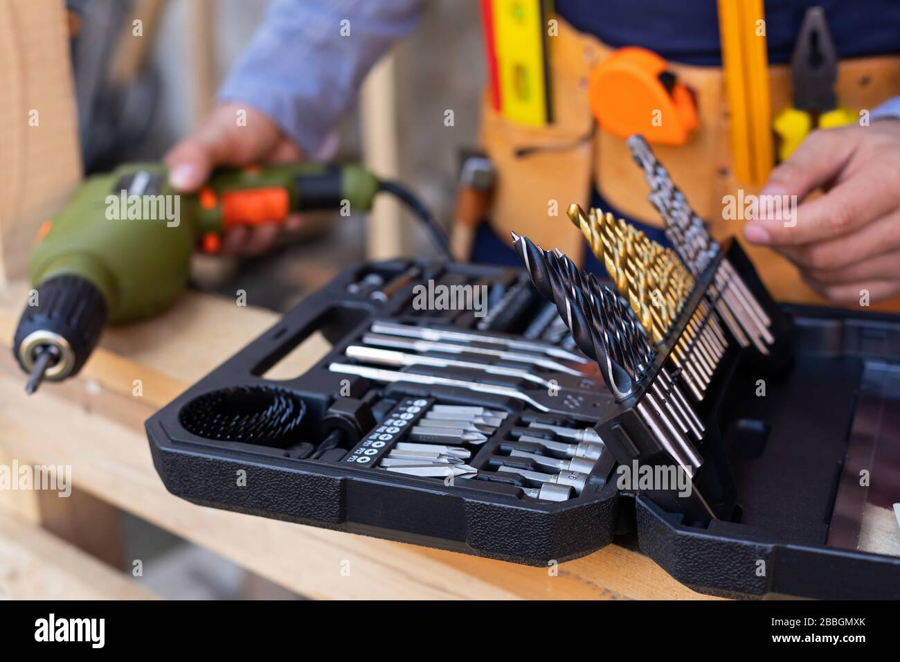 Close up picture of carpenters tool belt and work instruments on wooden ...