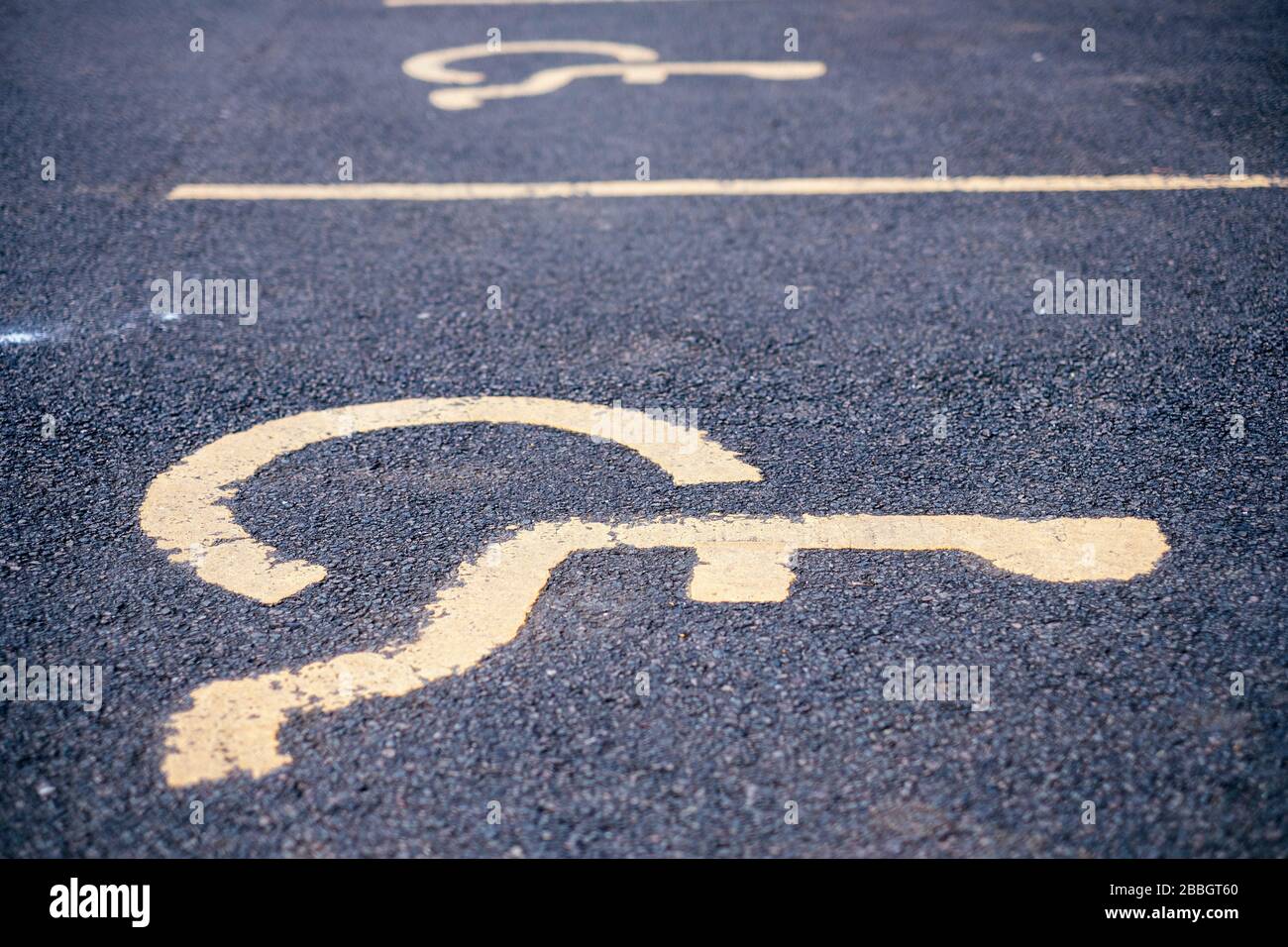Disable parking spaces in a community centre car park Stock Photo