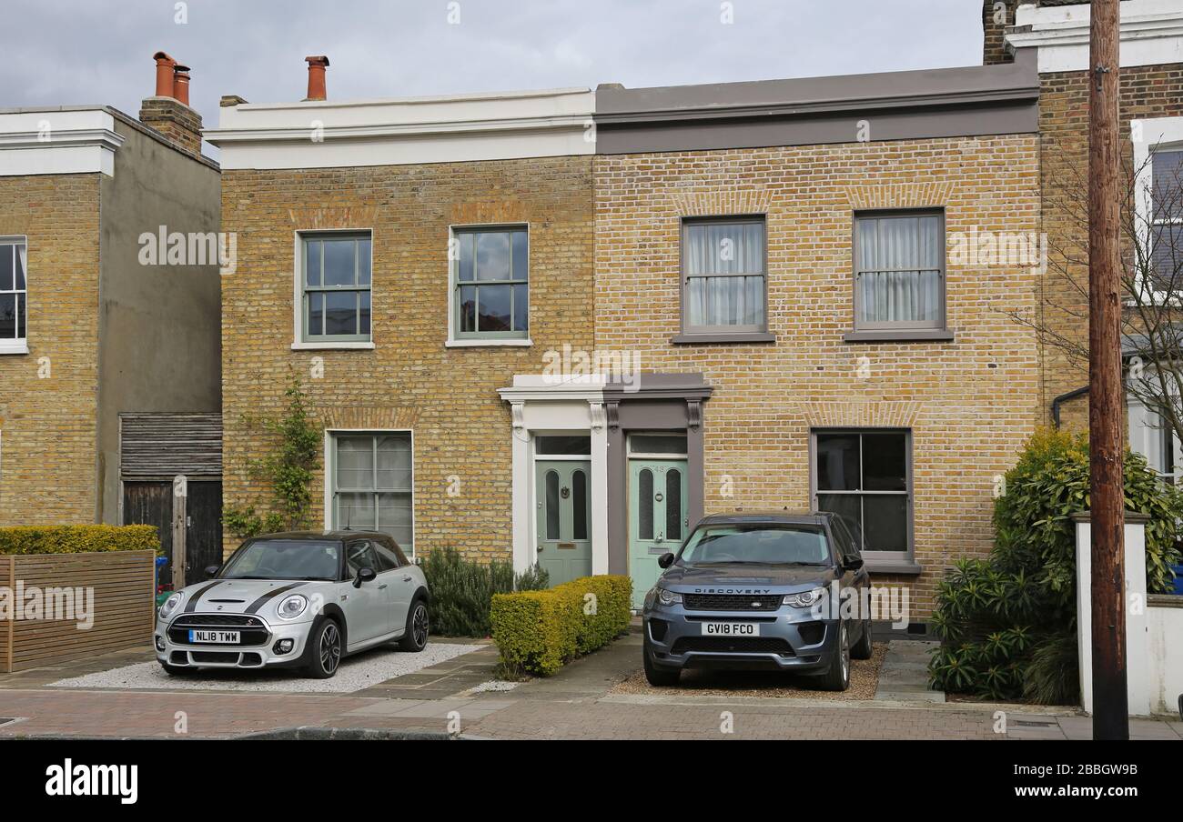 Victorian houses in South London that have converted their front gardens to allow car parking - avoiding council street parking permit charges. Stock Photo