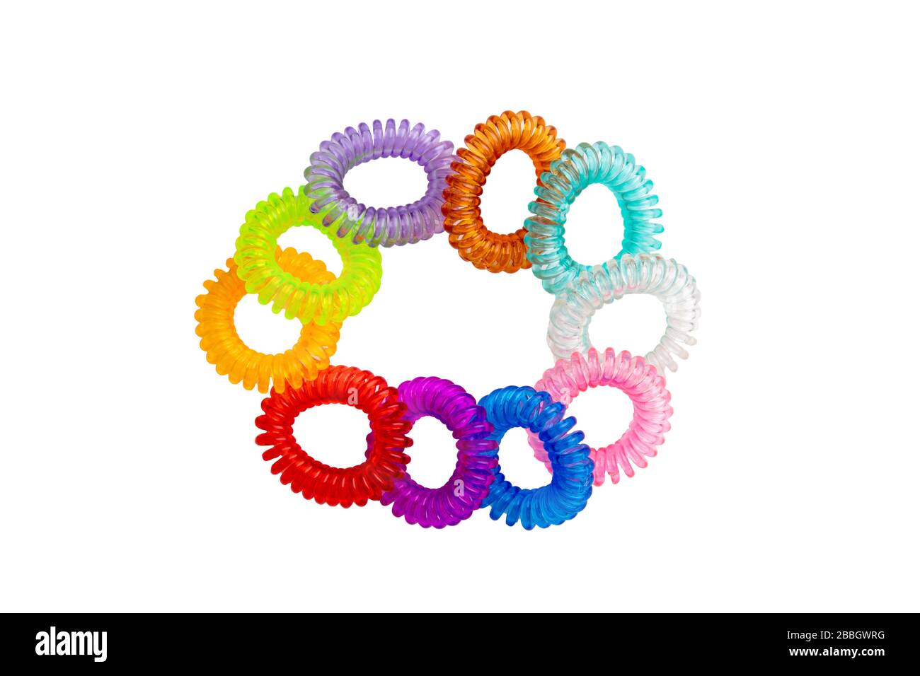 Hair care tools isolated. Close-up of multicolored elastic spiral scrunchies or hair bands for women hairstyling isolated on a white background. Tools Stock Photo