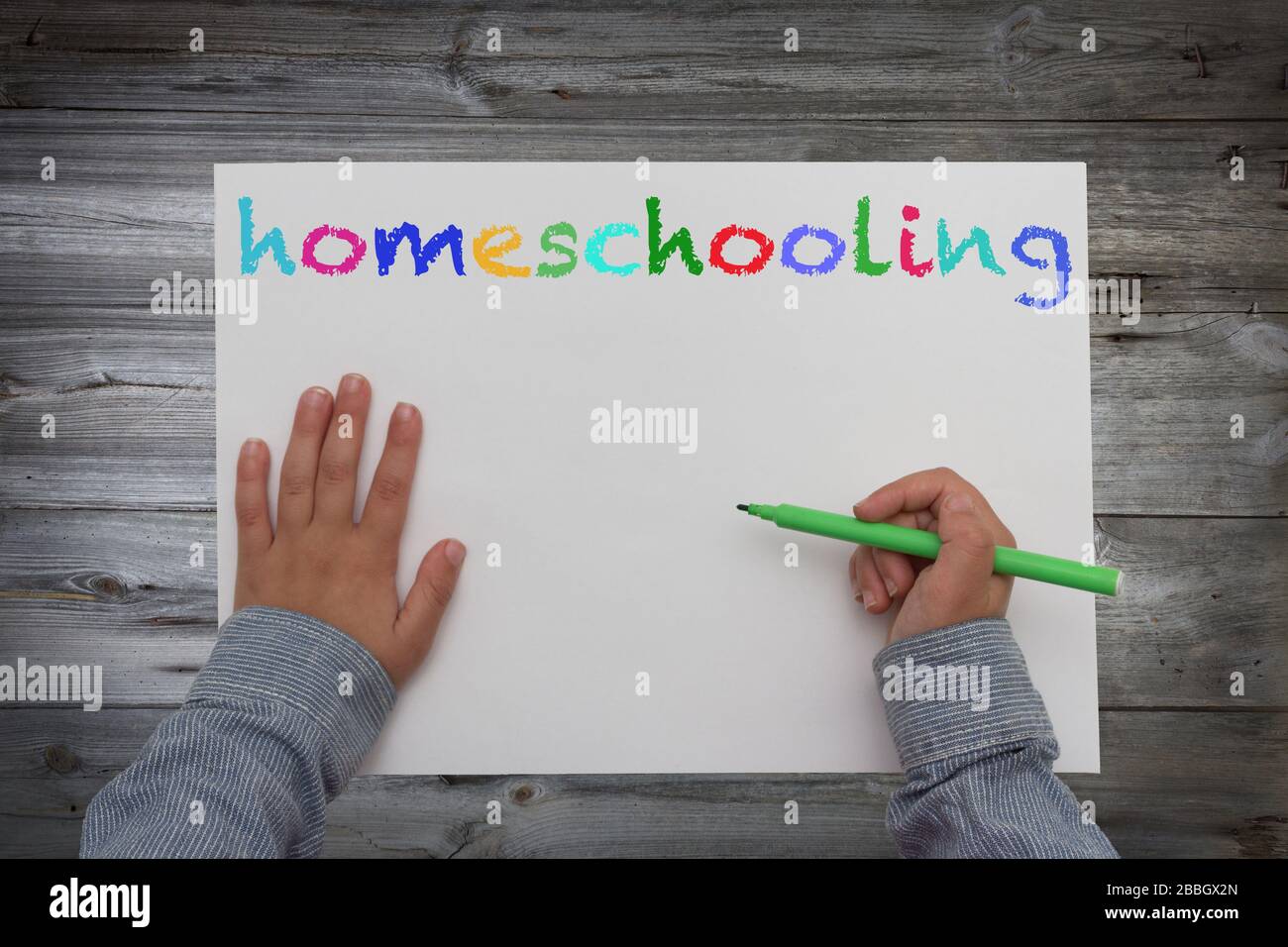 kid with pen and paper homeschooling concept Stock Photo