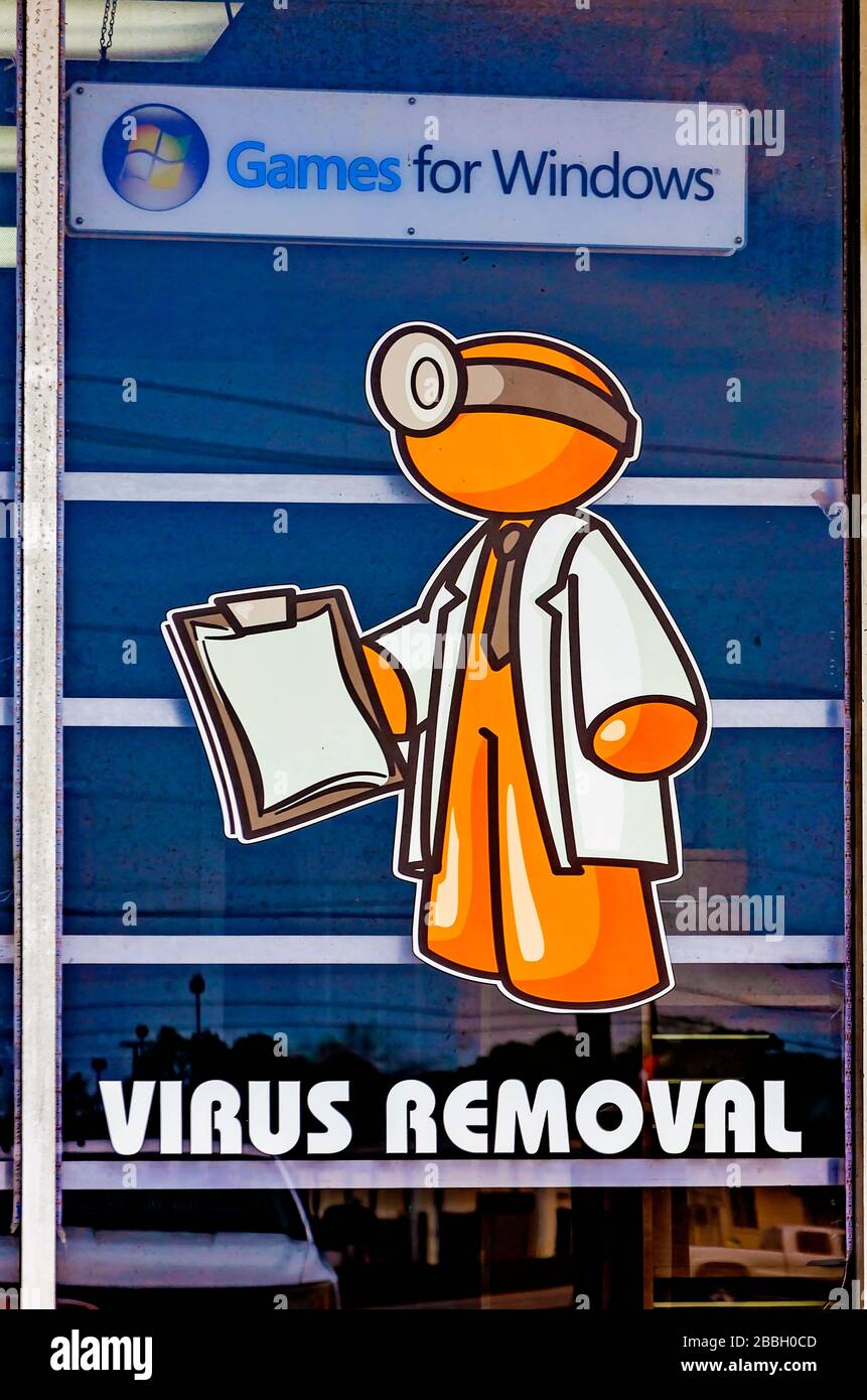A computer store advertises virus removal, March 29, 2020, in Theodore, Alabama. Computer viruses replicate themselves by modifying computer programs. Stock Photo