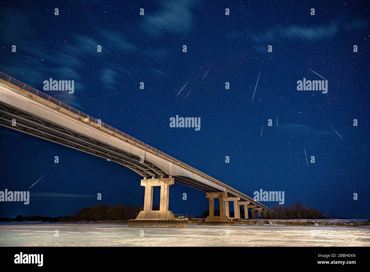 Multiple meteors under bridge to nowhere in Selkirk Manitoba Canada, composite of 4 images Stock Photo