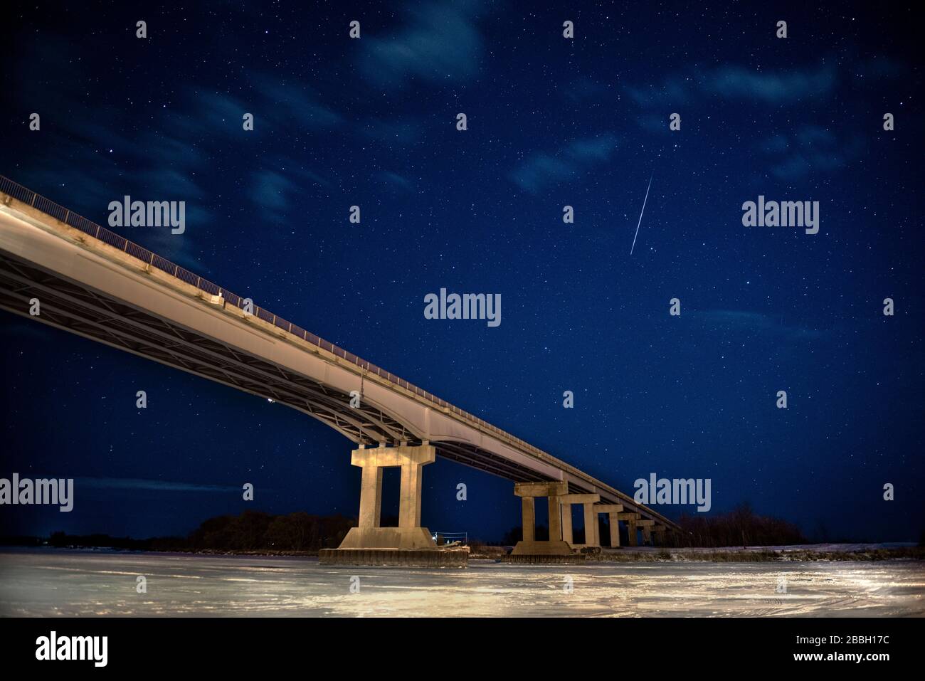 Meteor falls in sky above bridge to nowhere in Selkirk Manitoba Canada Stock Photo