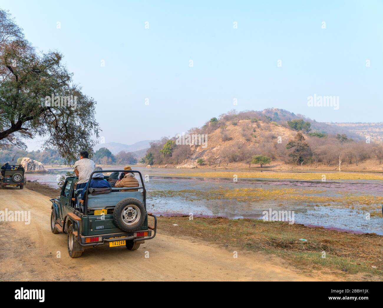 Tourists in a Gypsy safari vehicle on a Tiger Safari in Ranthambore National Park, Rajasthan, India Stock Photo