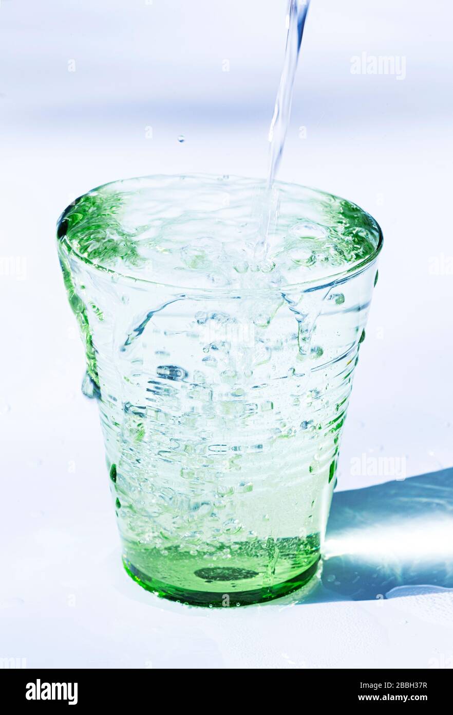 Pouring water into a glass Stock Photo Alamy