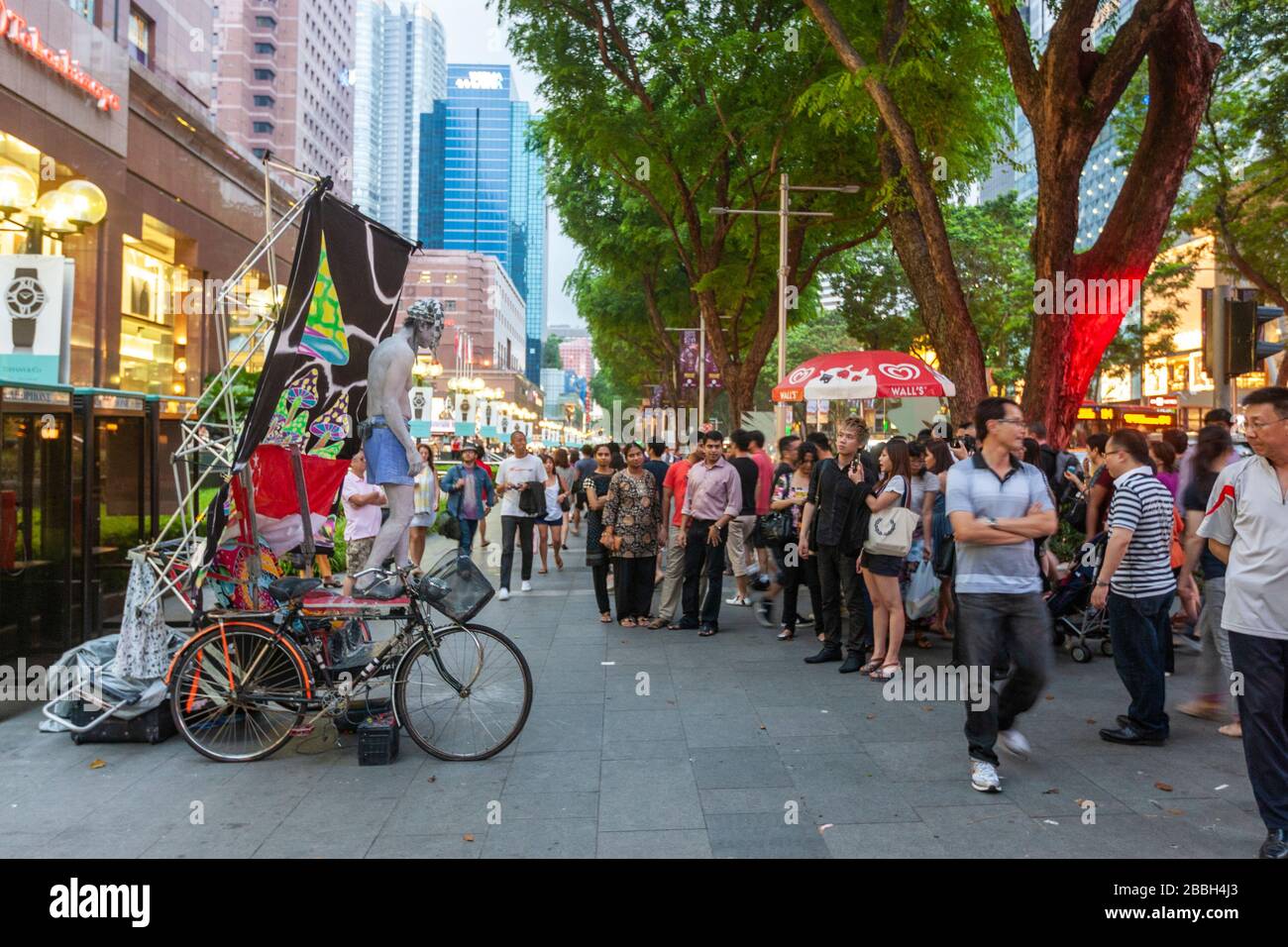 Street performed with spectators in  Orchard Rd, Singapore Stock Photo