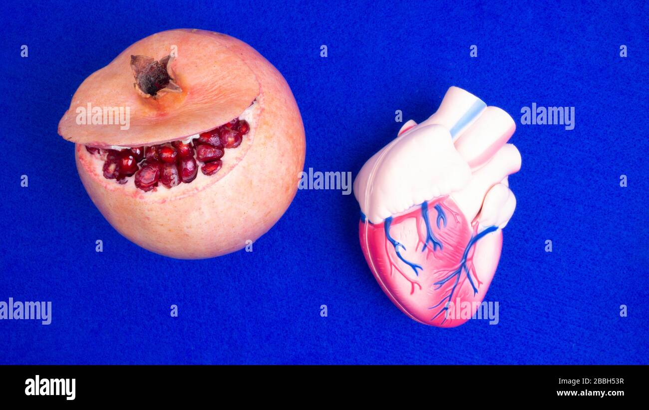 red juicy pomegranate and heart shape, Ripe organic pomegranate for