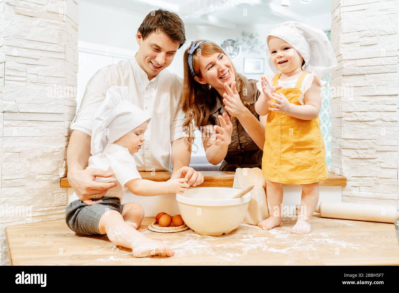 Happy cheerful young caucasian family in white cap Stock Photo