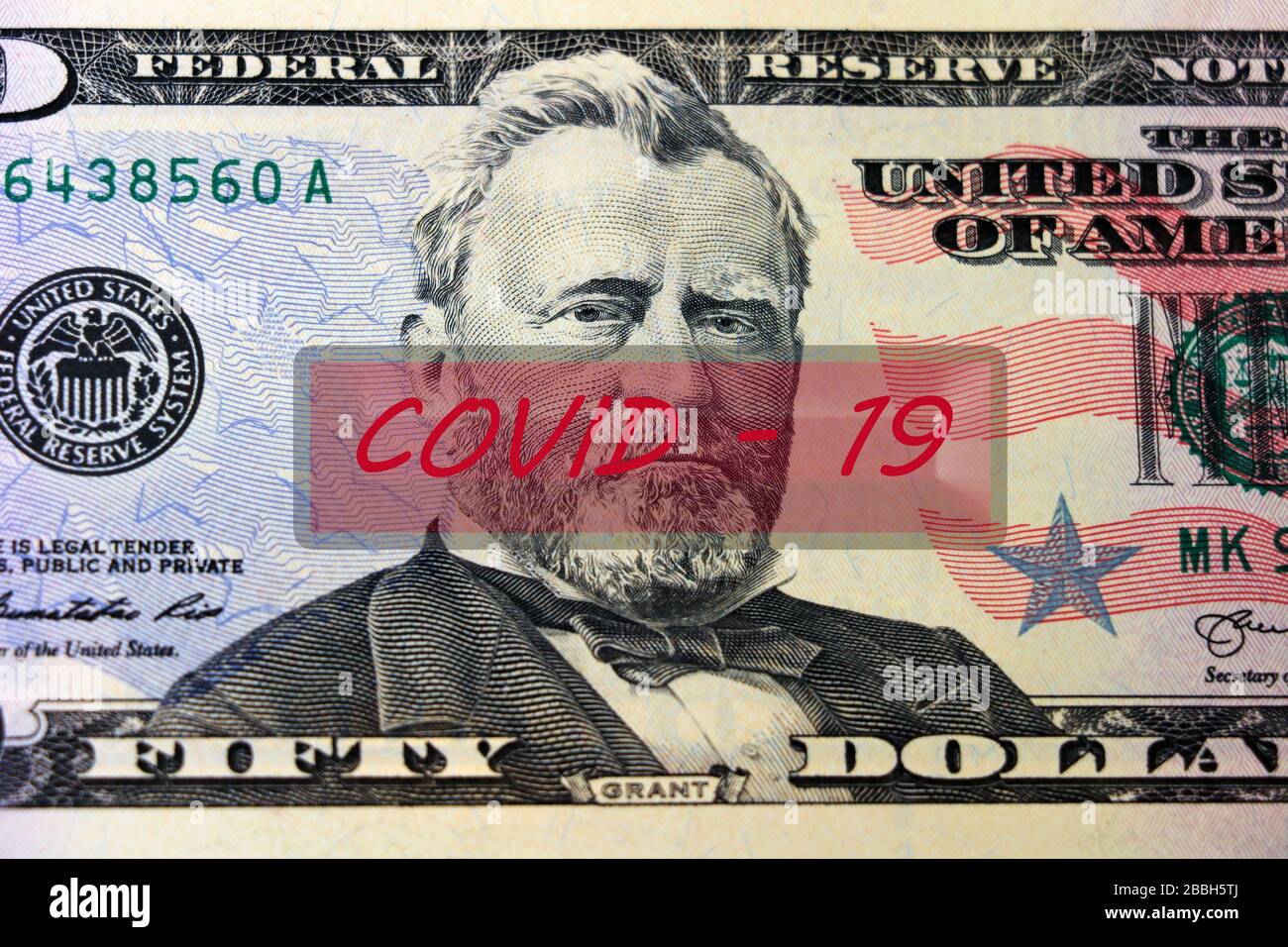 COVID-19 coronavirus in USA. 50 dollar money bill with coronavirus . COVID-19 affects global stock market. Crisis and finance concept. World economy hit by corona virus outbreak and pandemic fears Stock Photo