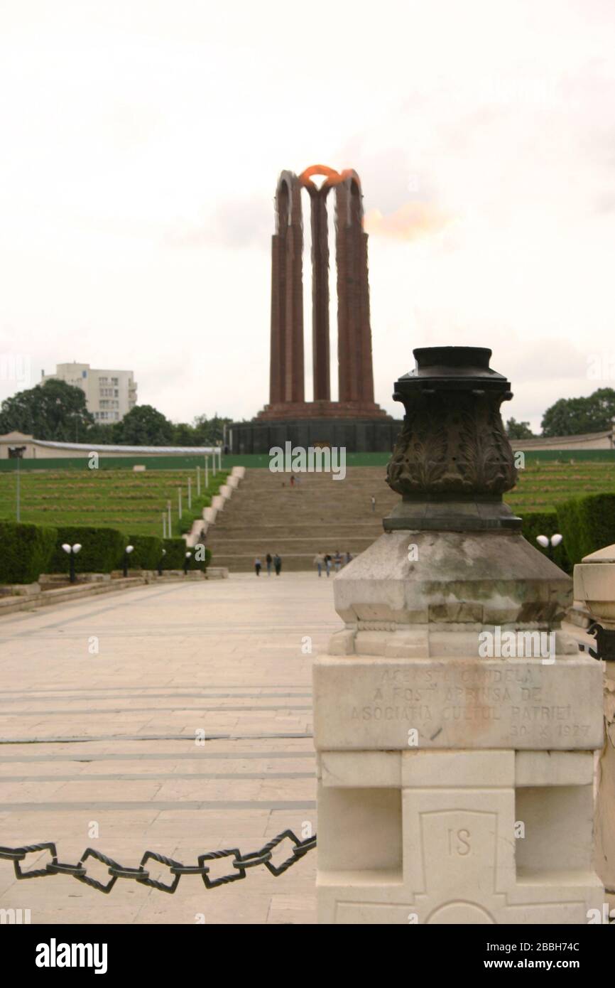 Bucharest, Romania. The Eternal Flame (foreground) and the Mausoleum (background) in Carol Park, honoring the Romanian heroes of WWI. Stock Photo