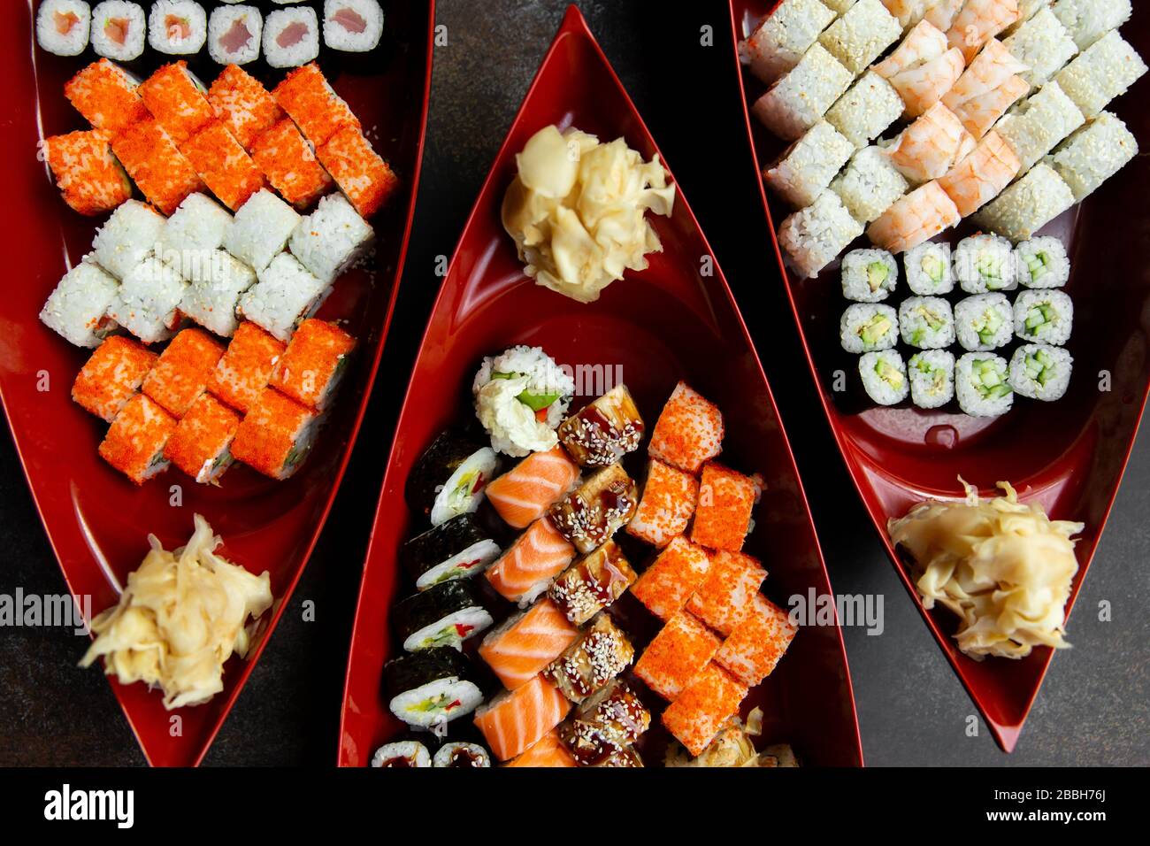 japanese sushi food. Various kinds of sushi served on a boat close up. Big set of rolls on a plate in a restaurant. Stock Photo