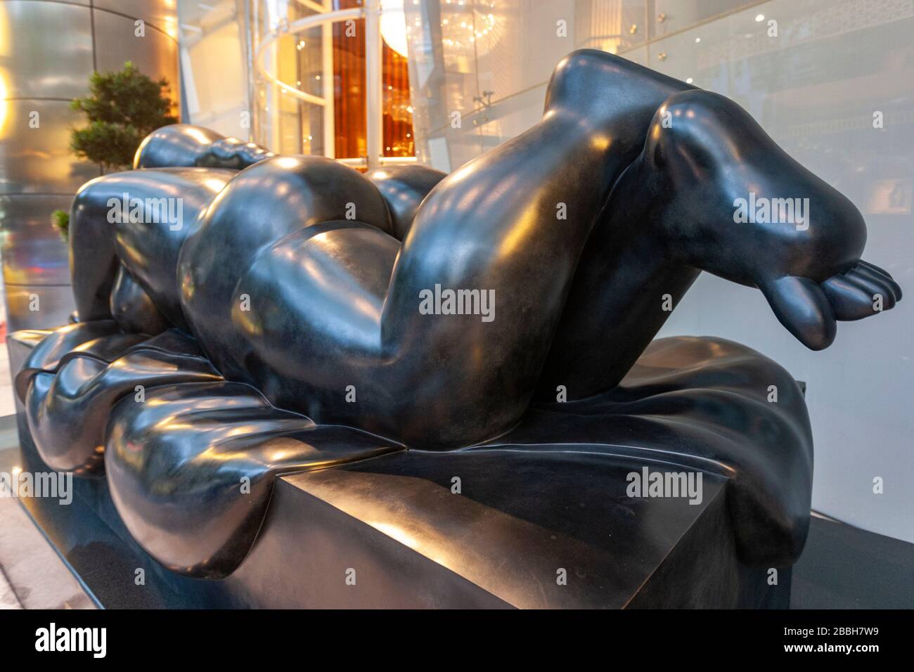 Monumental sculpture of a reclining woman by Fernando Botero, display at the St Regis Hotel, Singapore Stock Photo