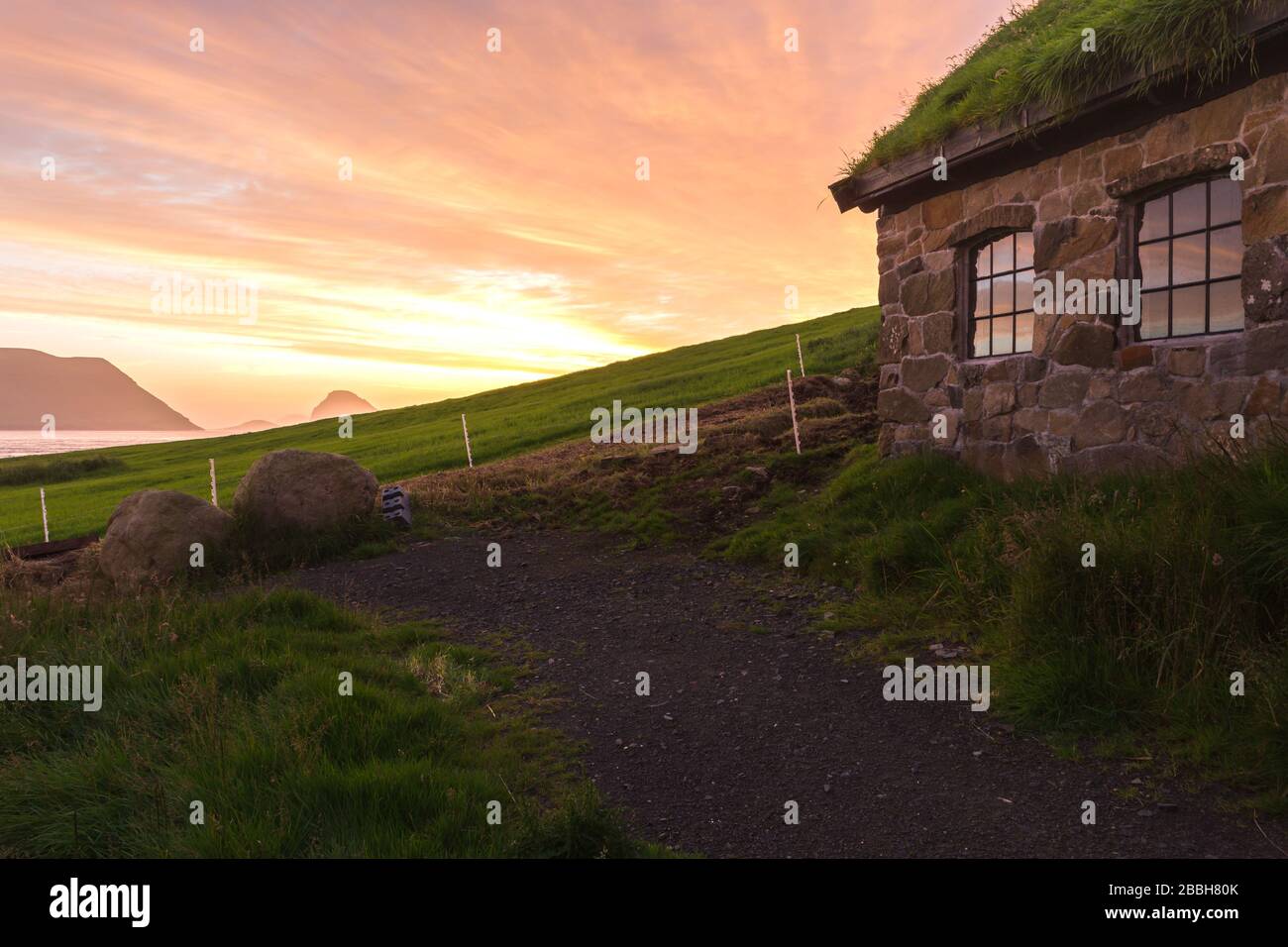 Kirkjubour house and Hestur in the distance, Streymoy, Faroe Islands Stock Photo