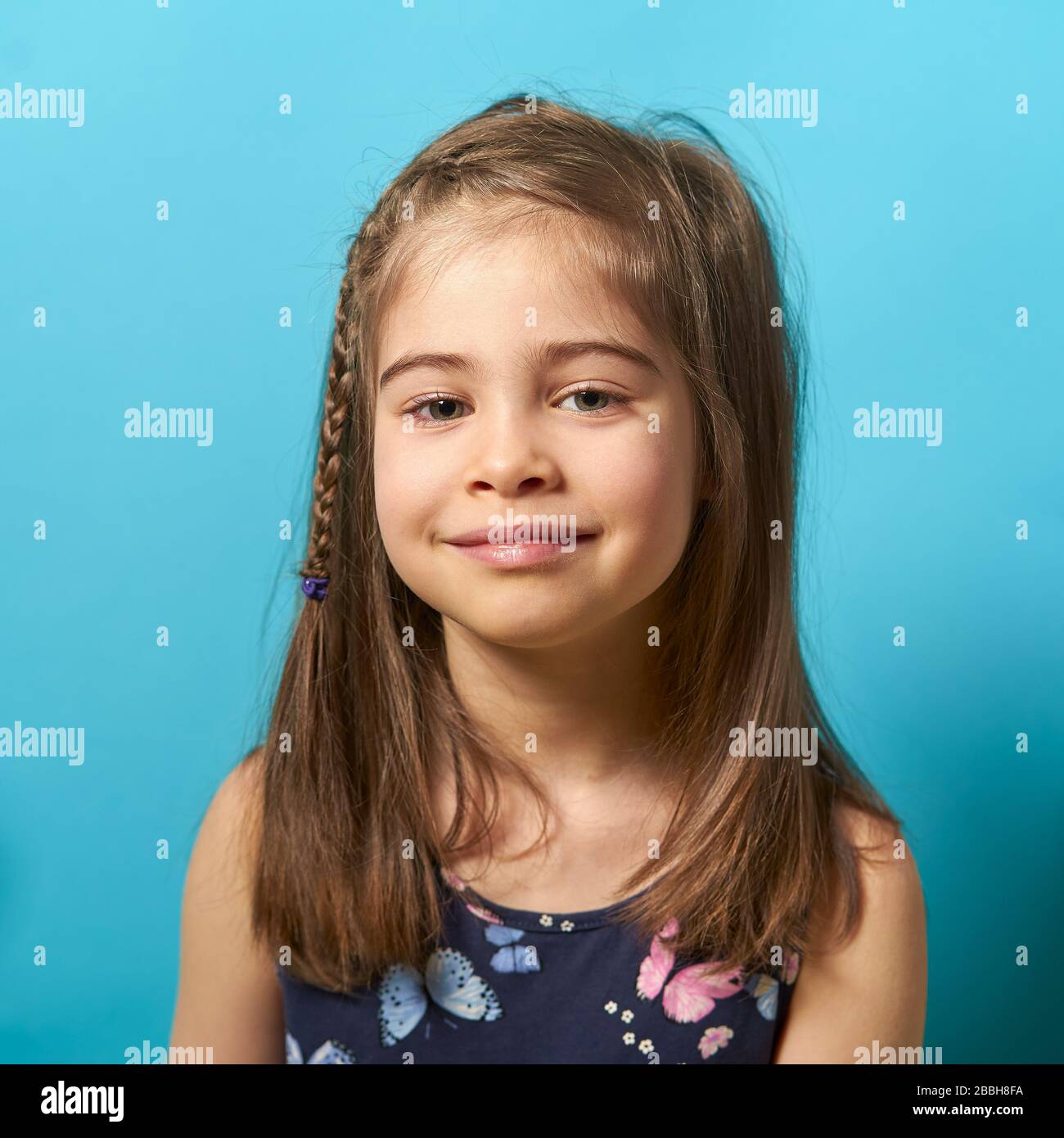 little girl in dress on blue background Stock Photo