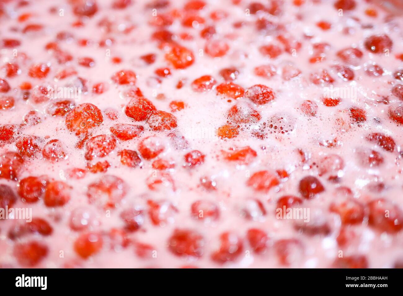 Strawberry jam cooking process. Organic traditional jam manufacturing