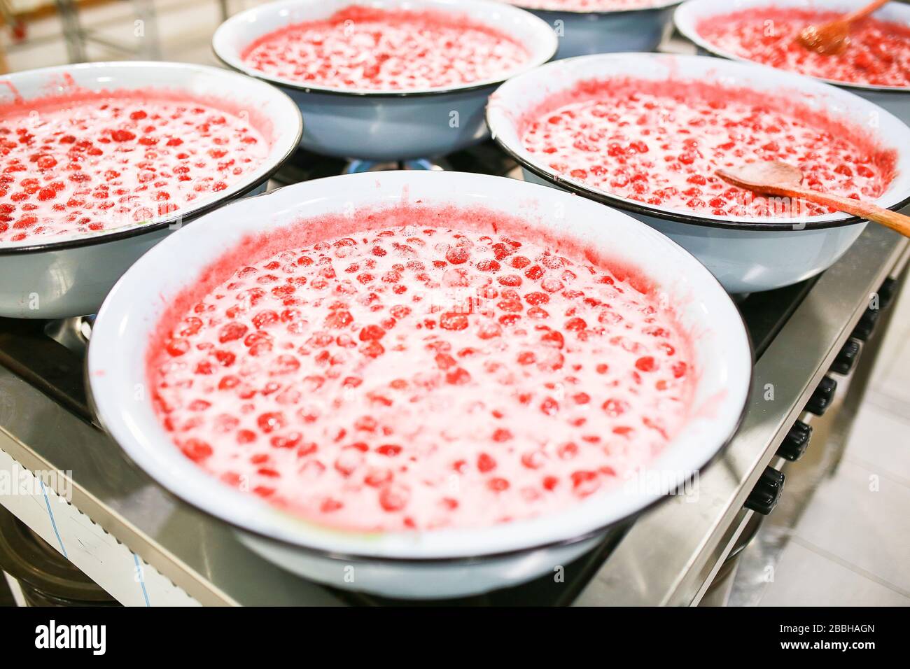 Strawberry jam cooking process. Organic traditional jam manufacturing