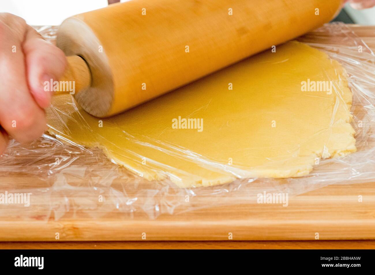 Roll out dough with rolling pin Stock Photo Alamy