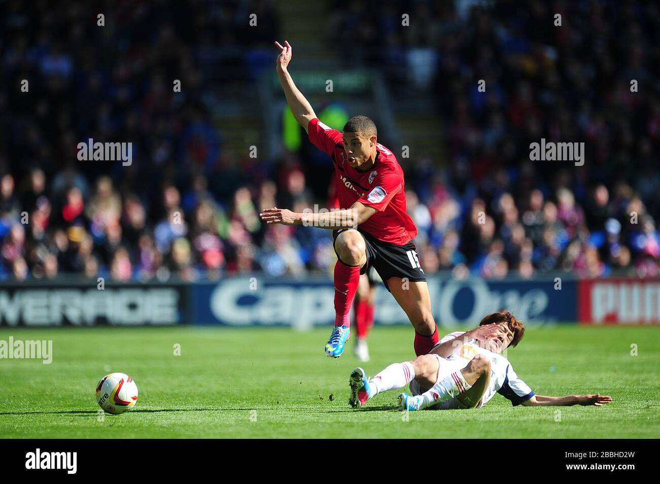 Cardiff City's Rudy Gestede (left) and Bolton Wanderers' Lee Chung-Yong (right) battle for the ball Stock Photo
