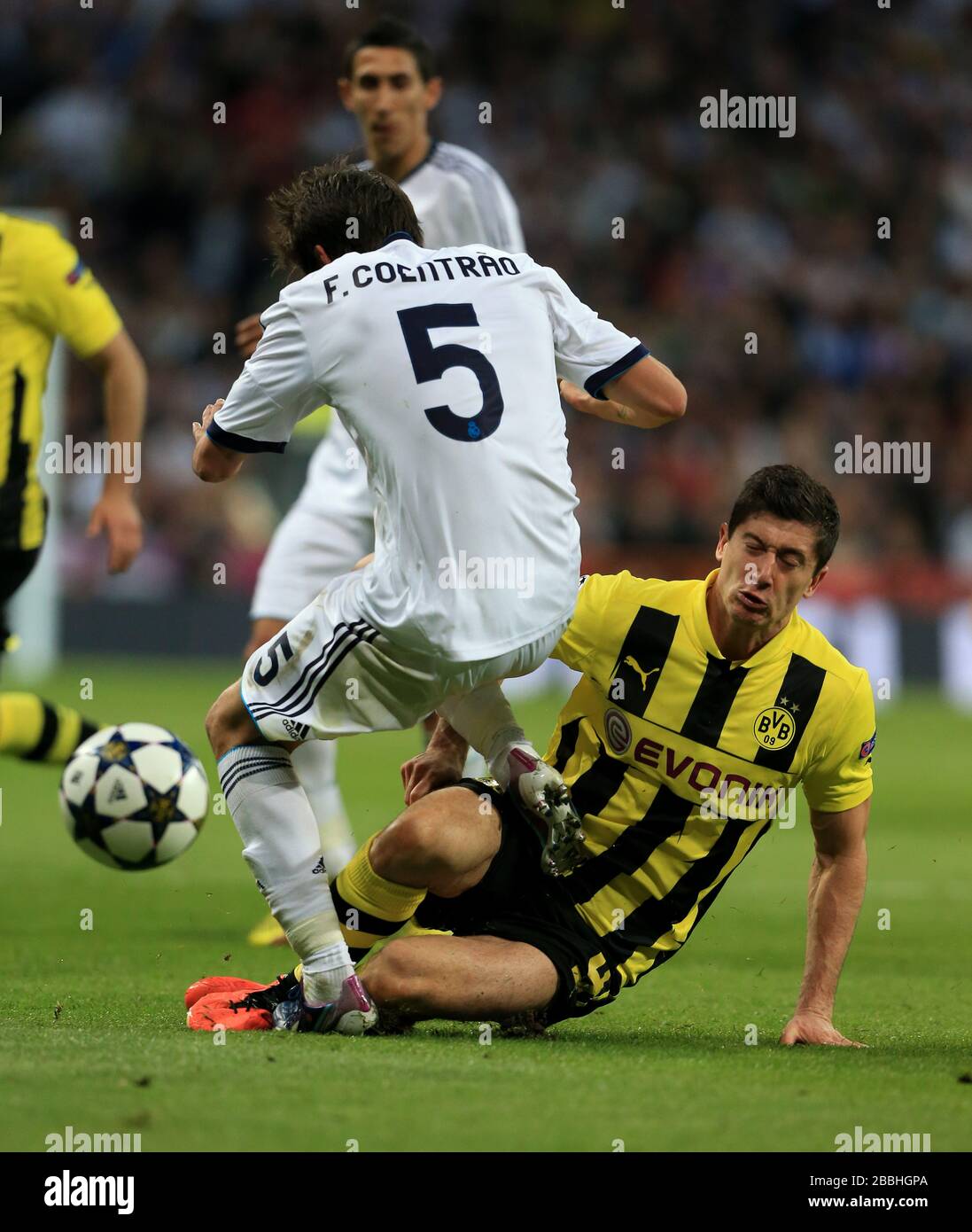 Real Madrid's Fabio Coentrao (left) and Borussia Dortmund's Robert Lewandowski in action Stock Photo