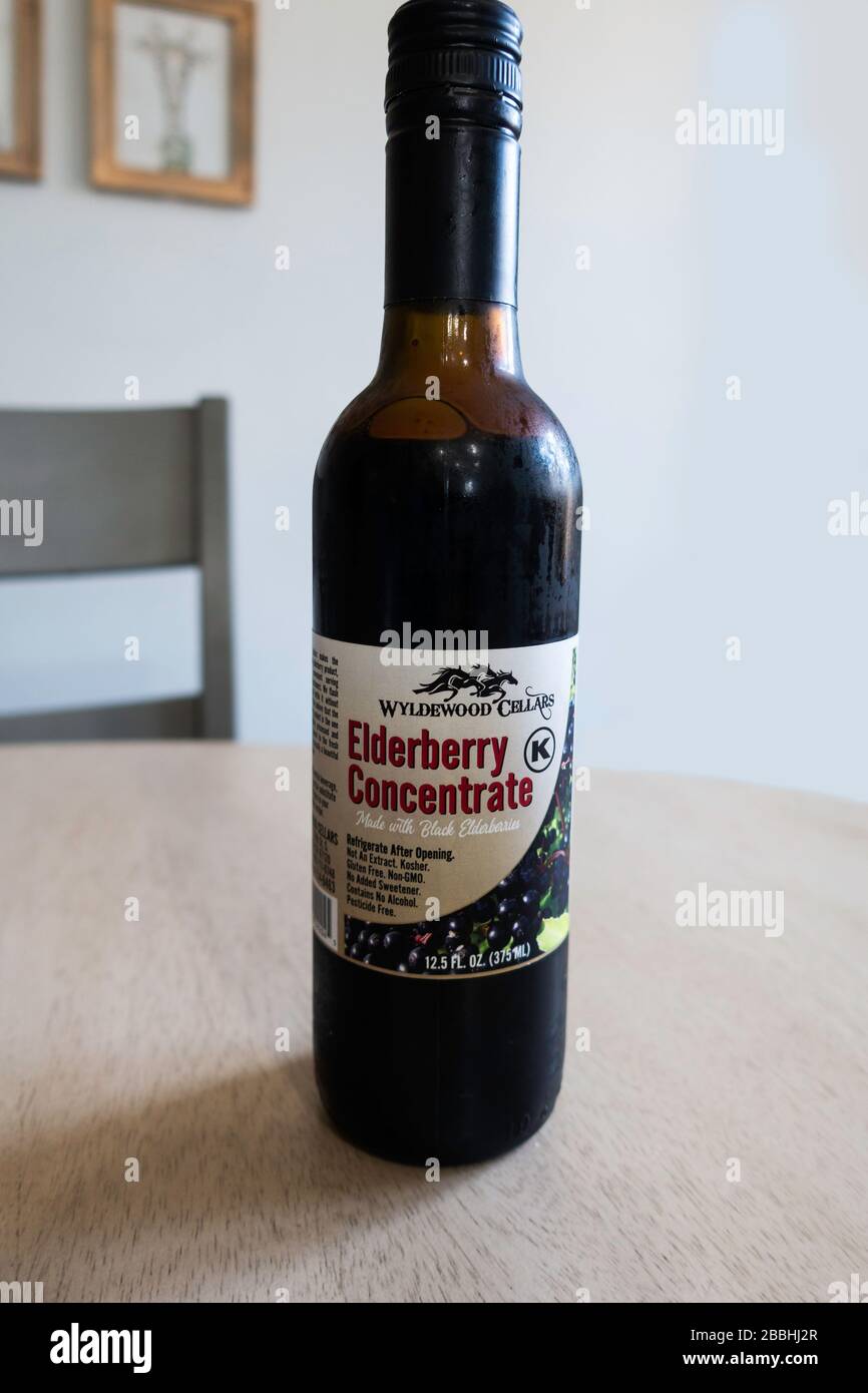 Bottle of elderberry concentrate for strengthening the immune system. Coronavirus, Covid-19 response. Stock Photo